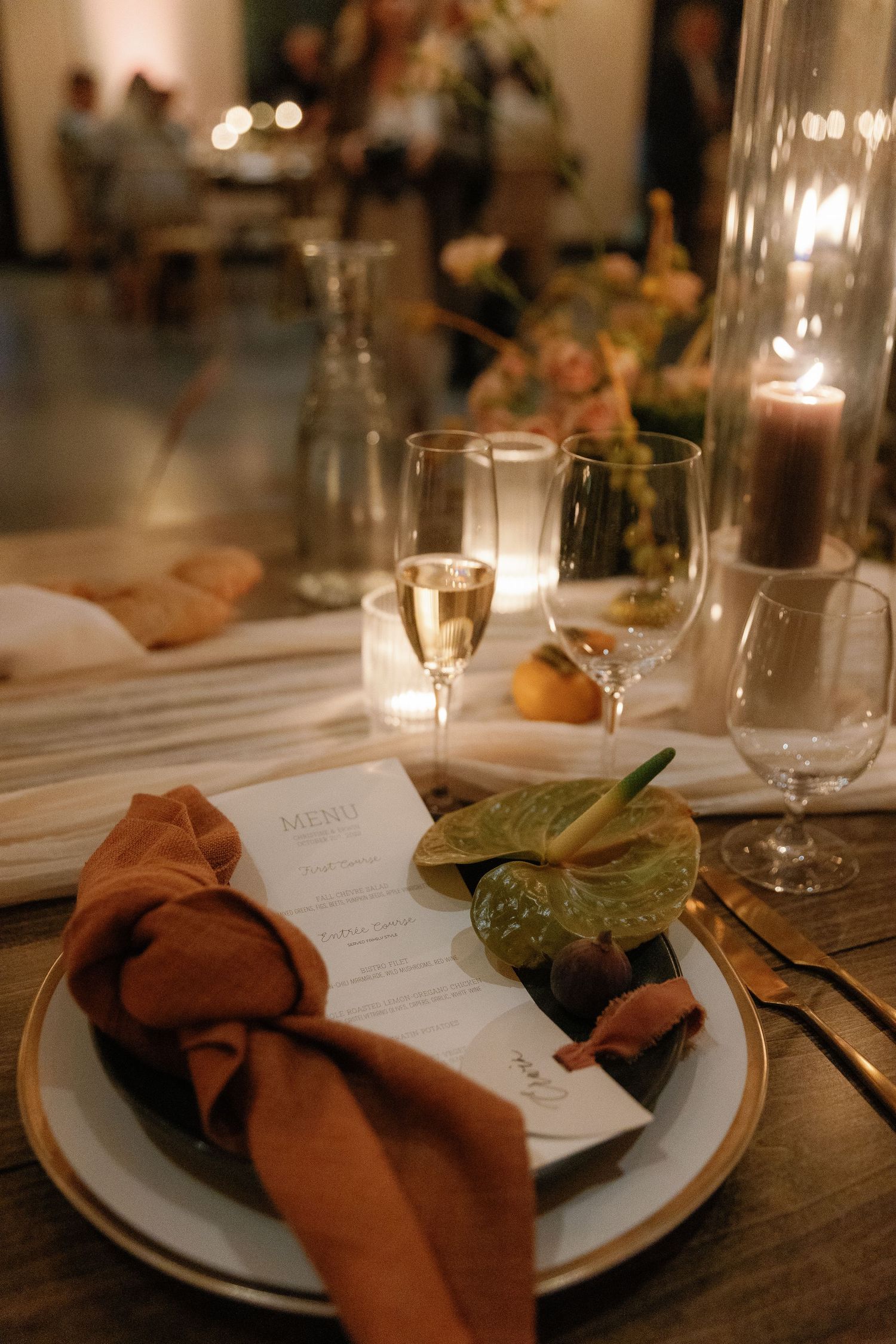 Elegant table setting with brown napkins, menu cards, and glassware for a formal dinner event.