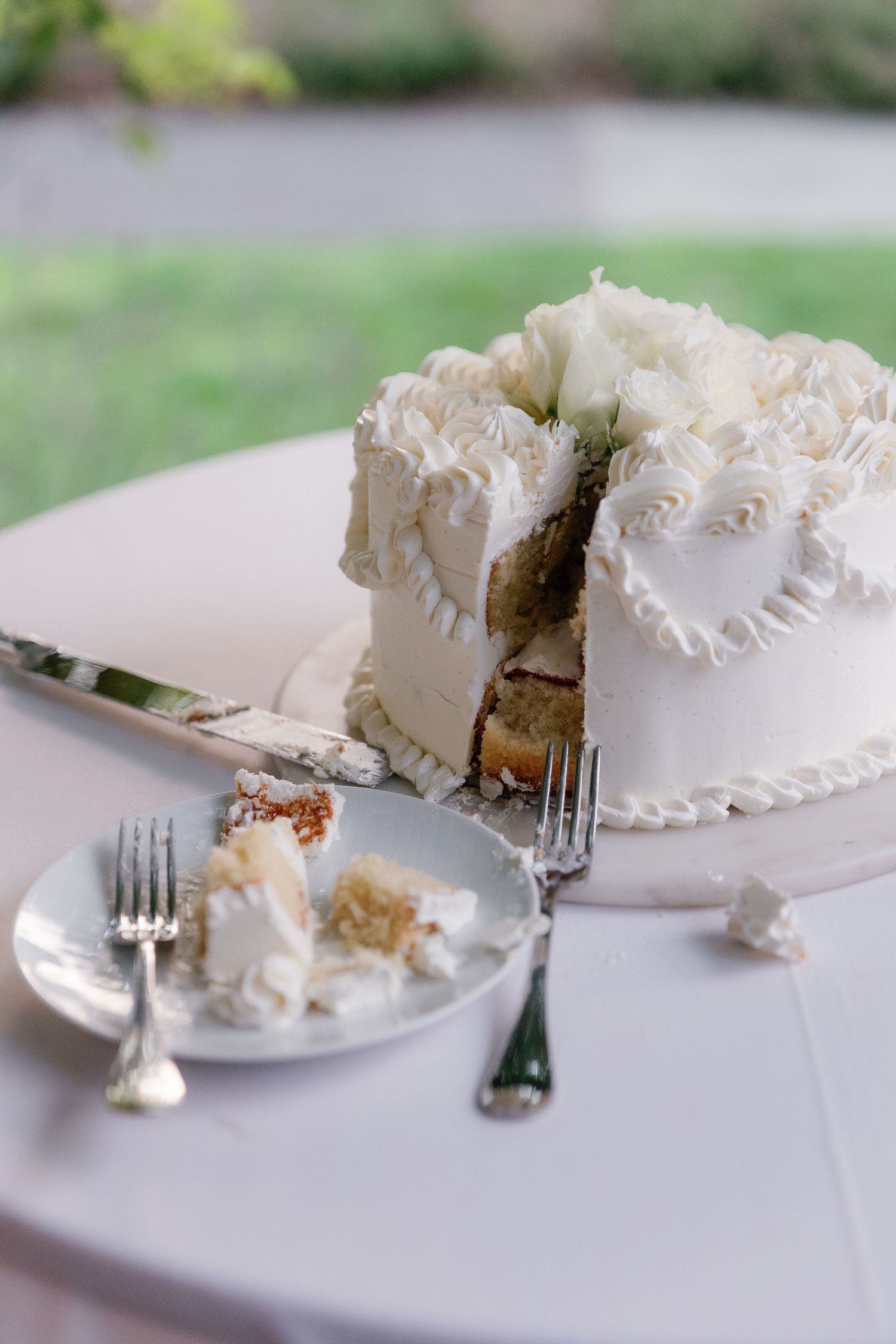 A series of white frosted cake slices on plates being eaten progressively from left to right.