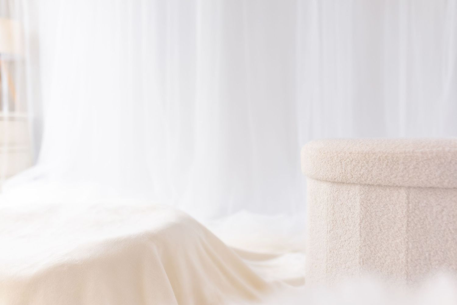 A close-up view of a white towel roll with a soft, textured surface against a blurred background.