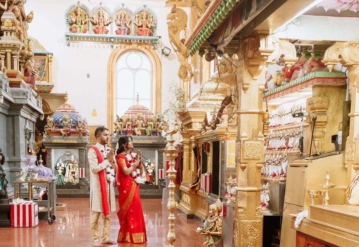 Ornate interior panorama of a vintage fairground carousel with decorated panels and mirrors displays colorful craftsmanship.