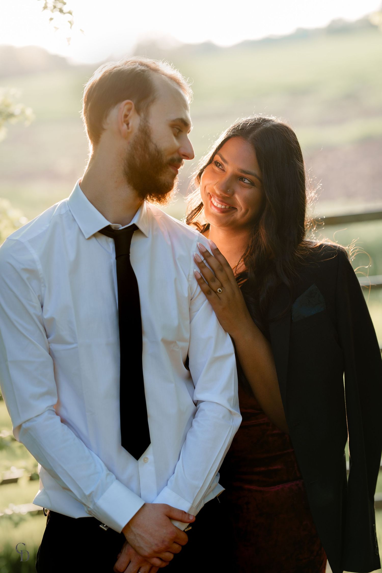 Joyful couple sharing intimate moment during golden hour photoshoot.