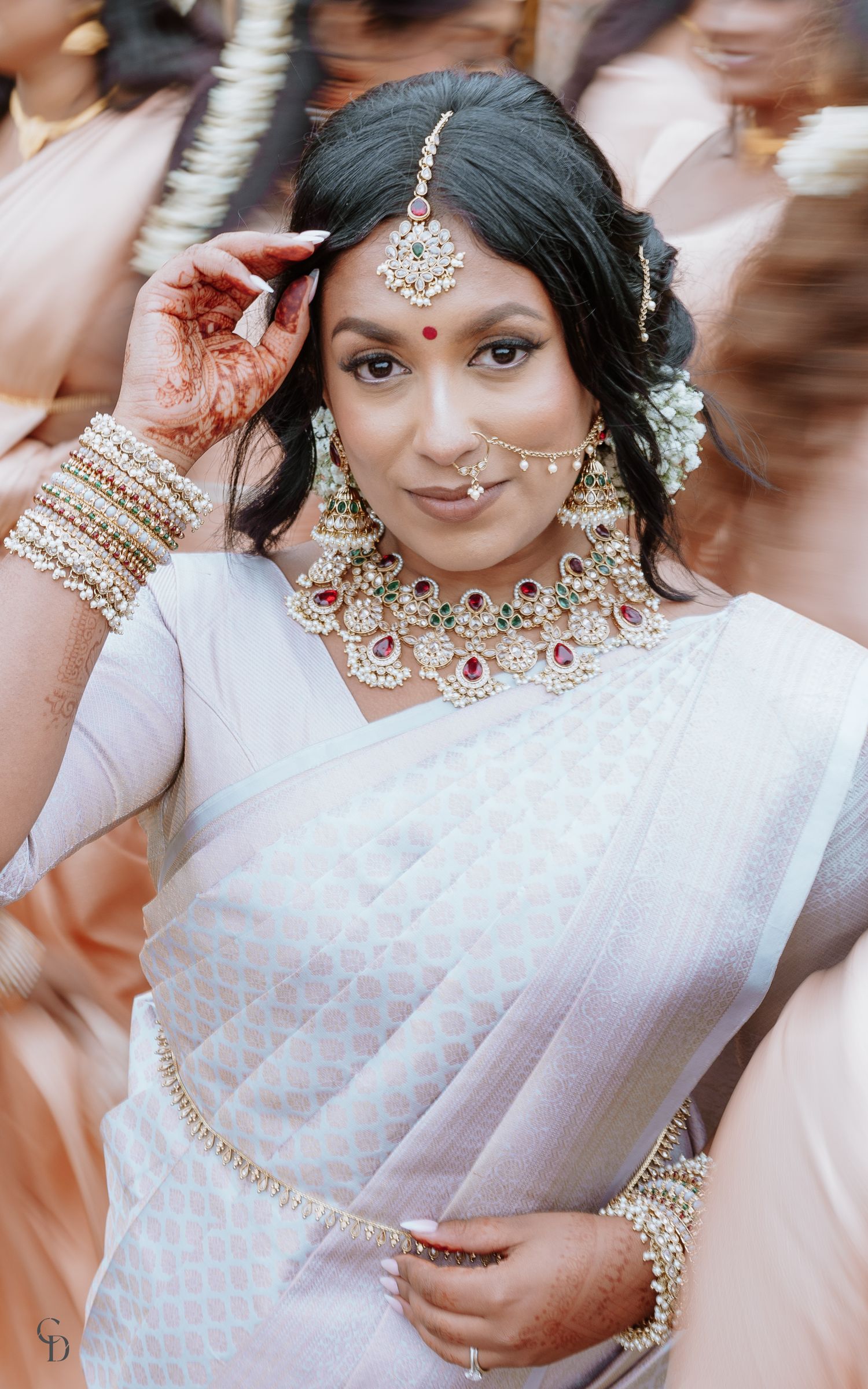 Traditional Indian bridal look with intricate jewelry and white saree.