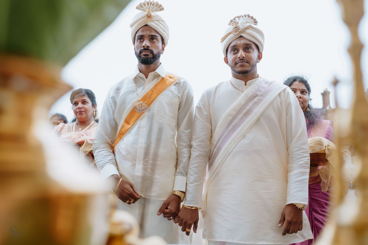 Wedding ceremony with men in traditional white Indian formal wear.