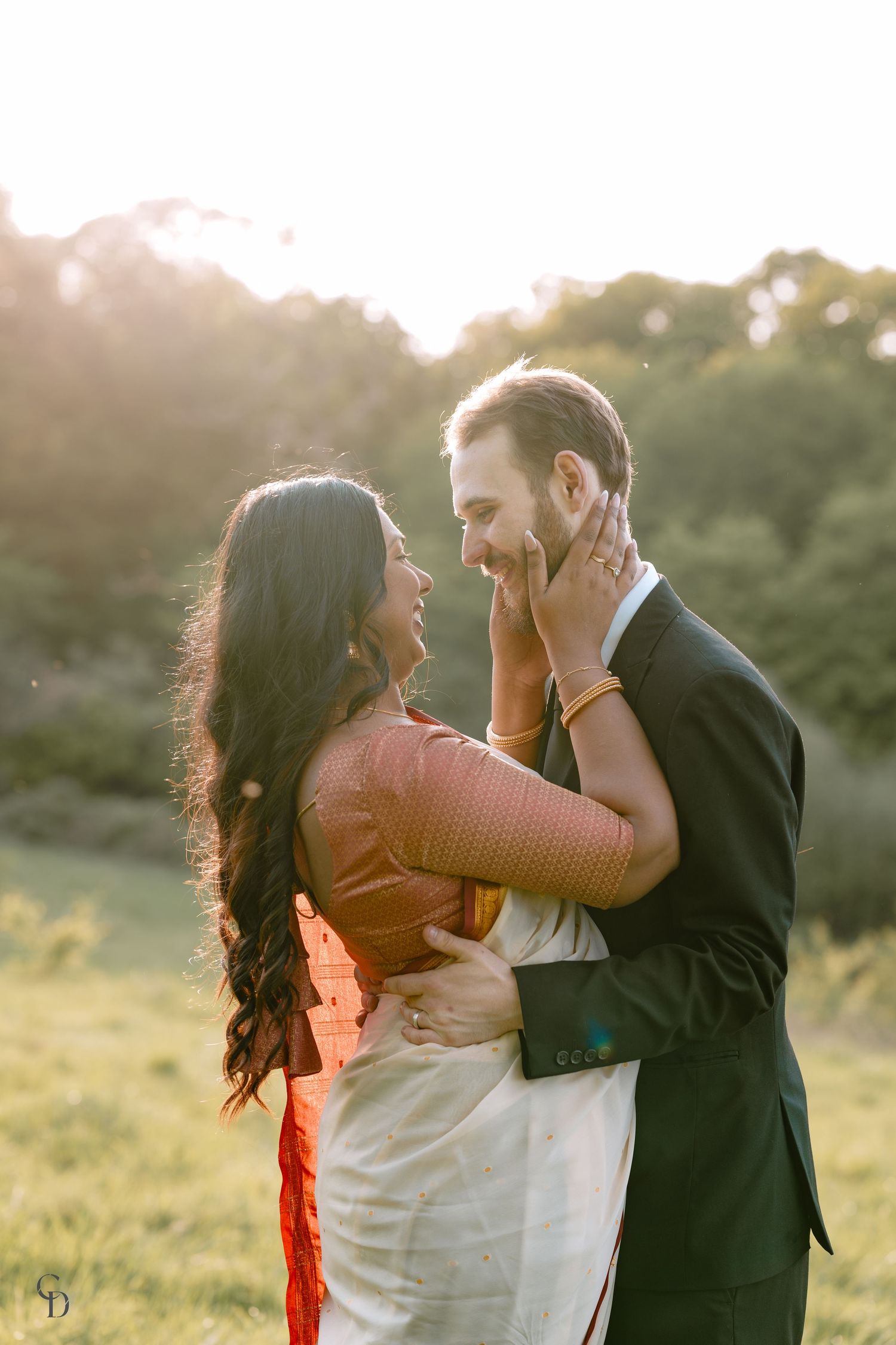 Intimate embrace captured during outdoor couple's photoshoot at golden hour.