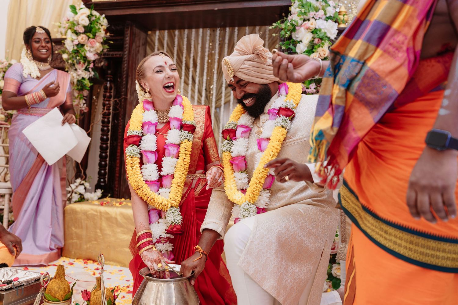 A joyful moment during a traditional Hindu wedding ceremony.