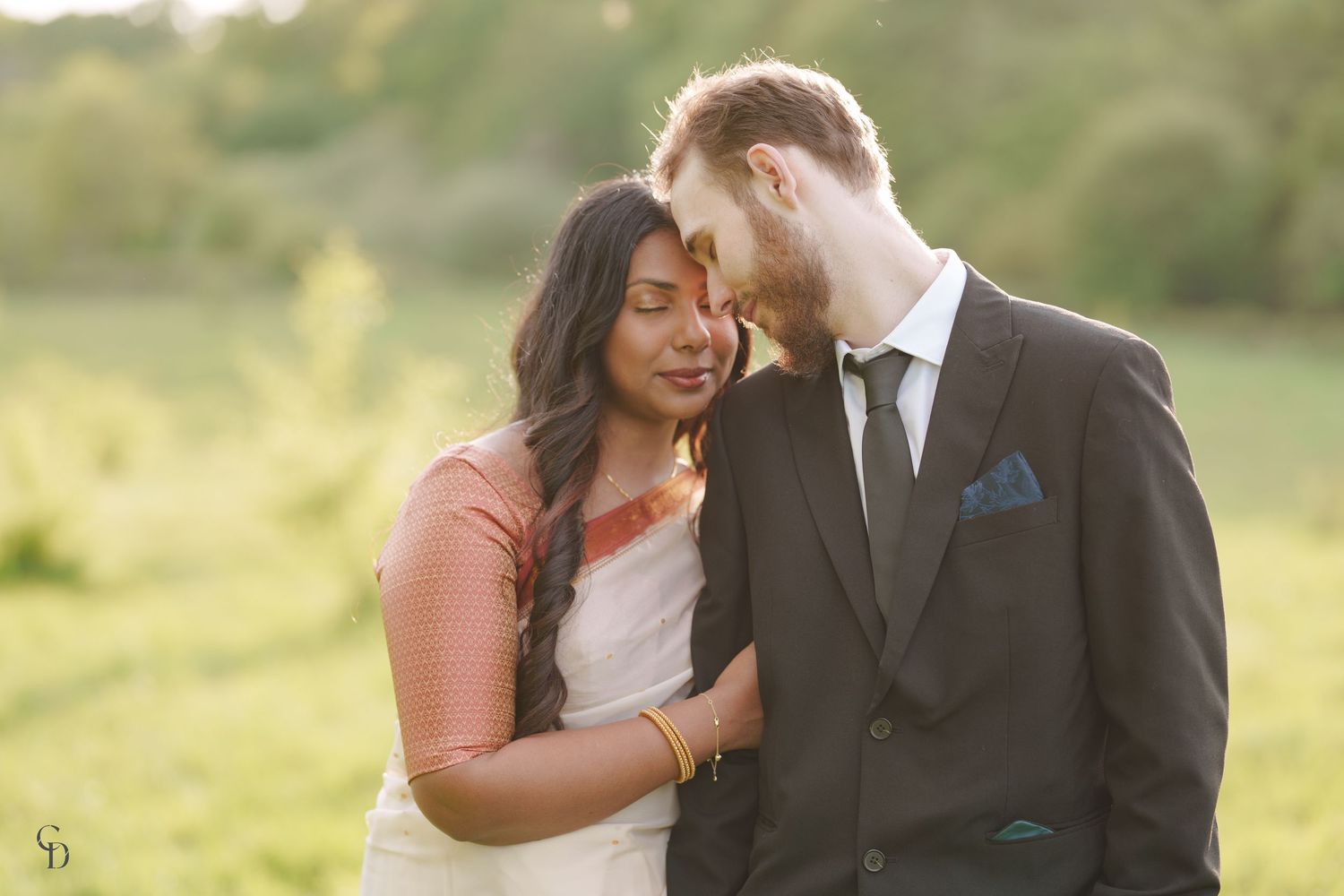 Intimate sunset wedding portrait with couple sharing tender moment in golden light.