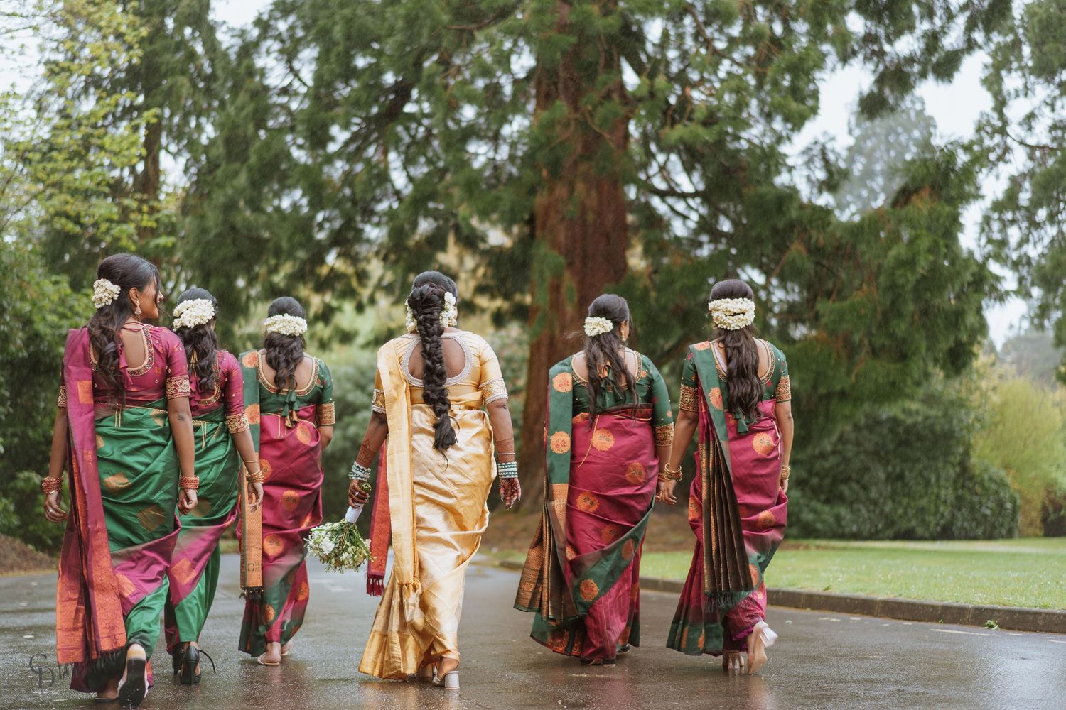 A group wearing colorful traditional South Asian attire walking together outdoors.