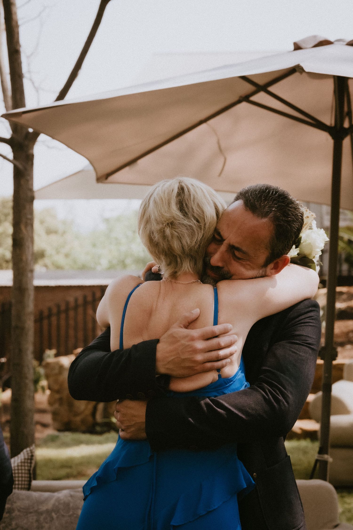 Groom hugs bride