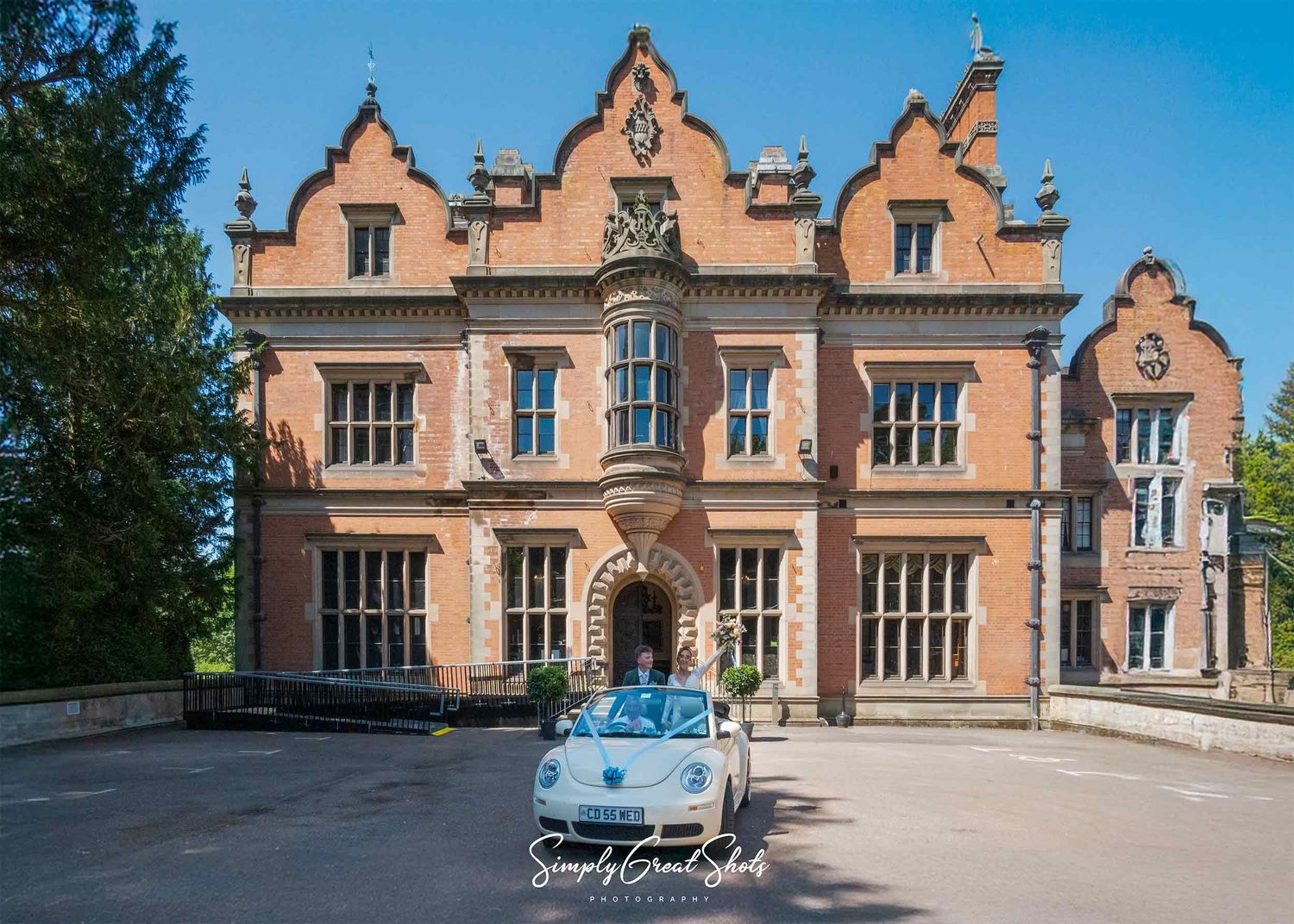 Beaumont Hall wedding photographer captures bride & groom celebrating in their VW Beetle wedding car