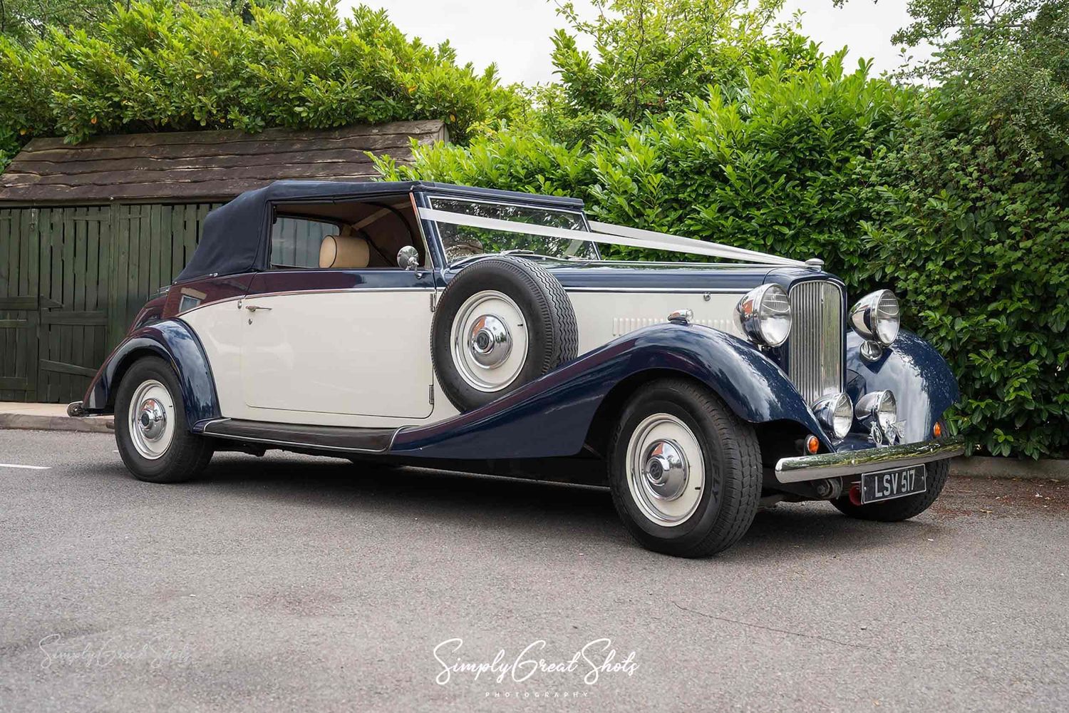 A classic wedding car waits to transport the bride and father-of-the-bride to their Coventry wedding