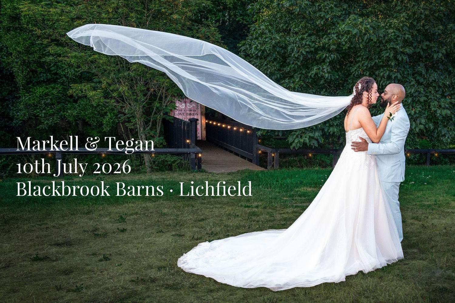Markell and Tegan stand together as Tegan’s veil lifts in the air at Blackbrook Barns during their Lichfield wedding.