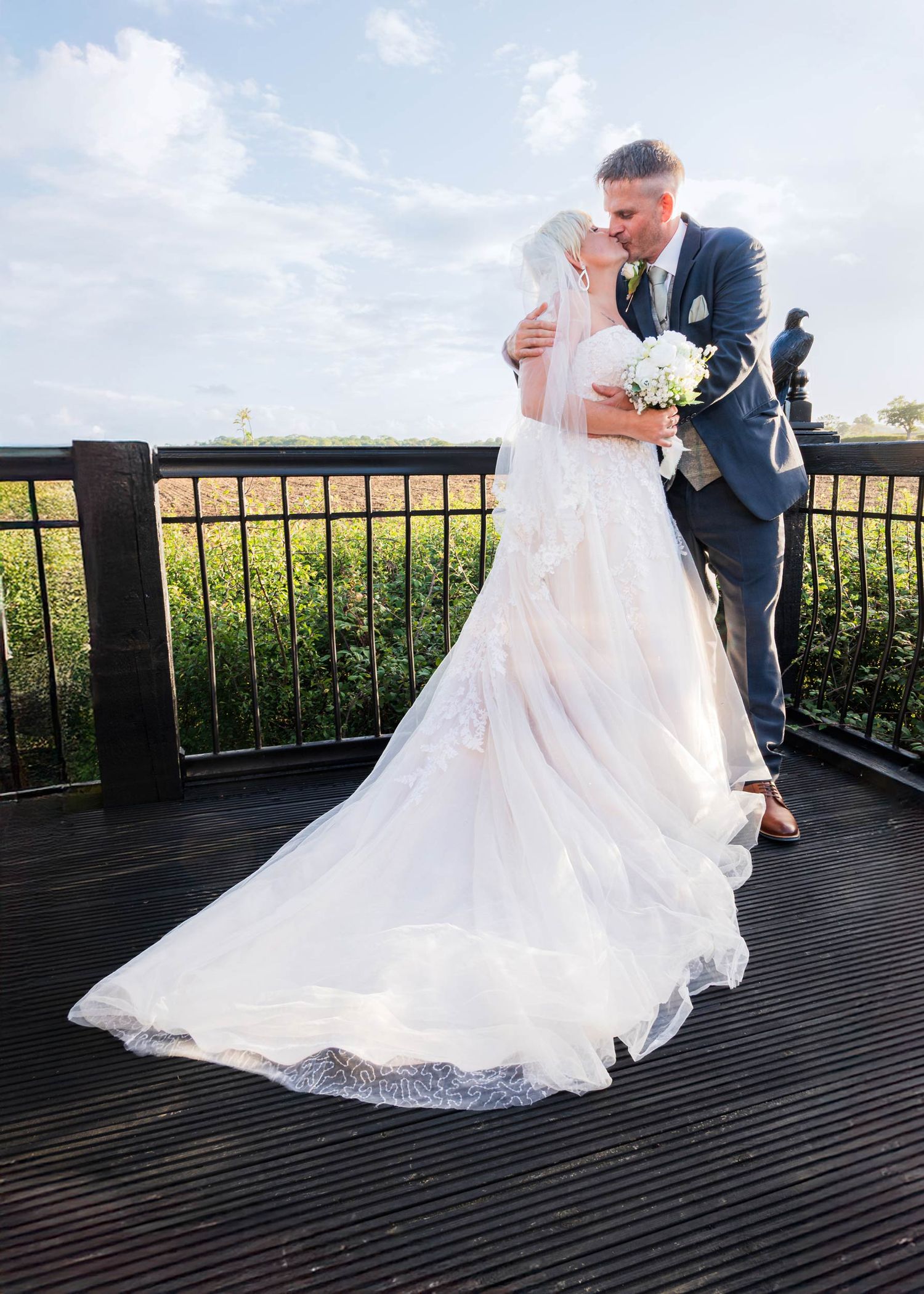Craig the groom and Faye the bride share an intimate moment on the balcony of Ember Eve Barn at Winters Tale Country Barn.