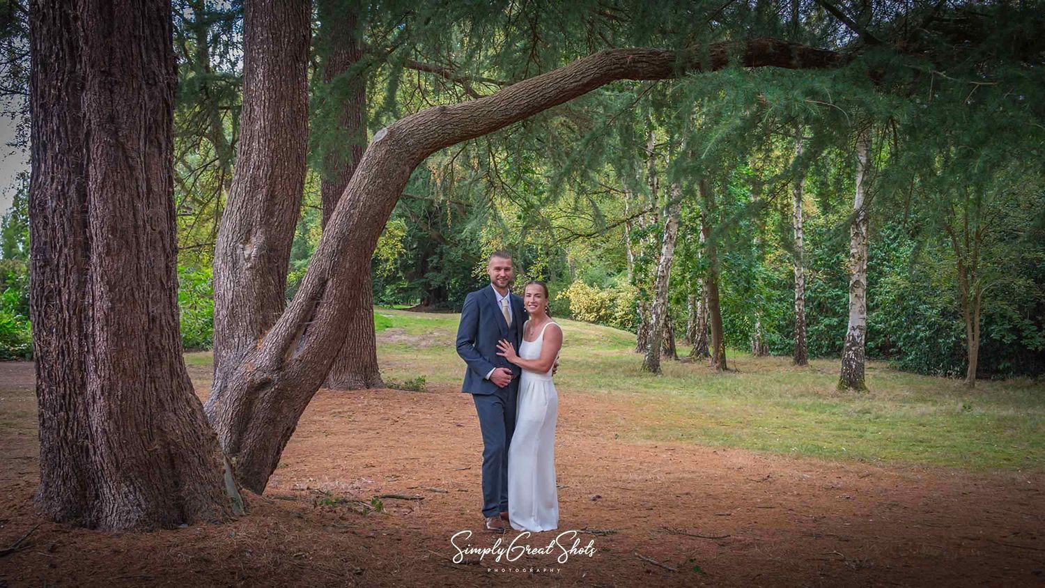 Hampton Manor wedding photographer captures Maddie-Hinch (OBE) and her husband Brendan posing under an ancient tree