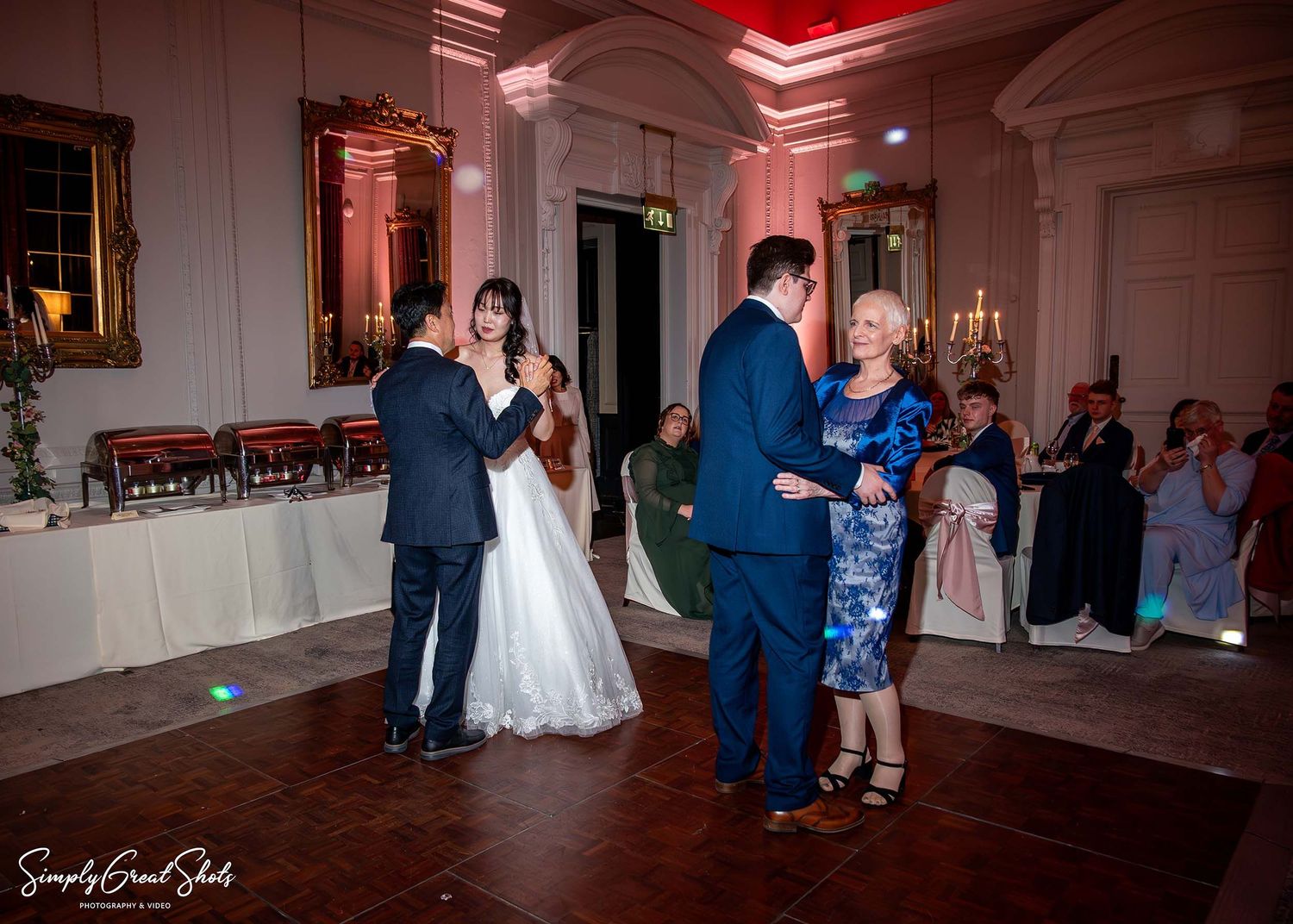 SimplyGreatShots capturing Mark and Minky dancing with parents during the wedding reception at Coombe Abbey.