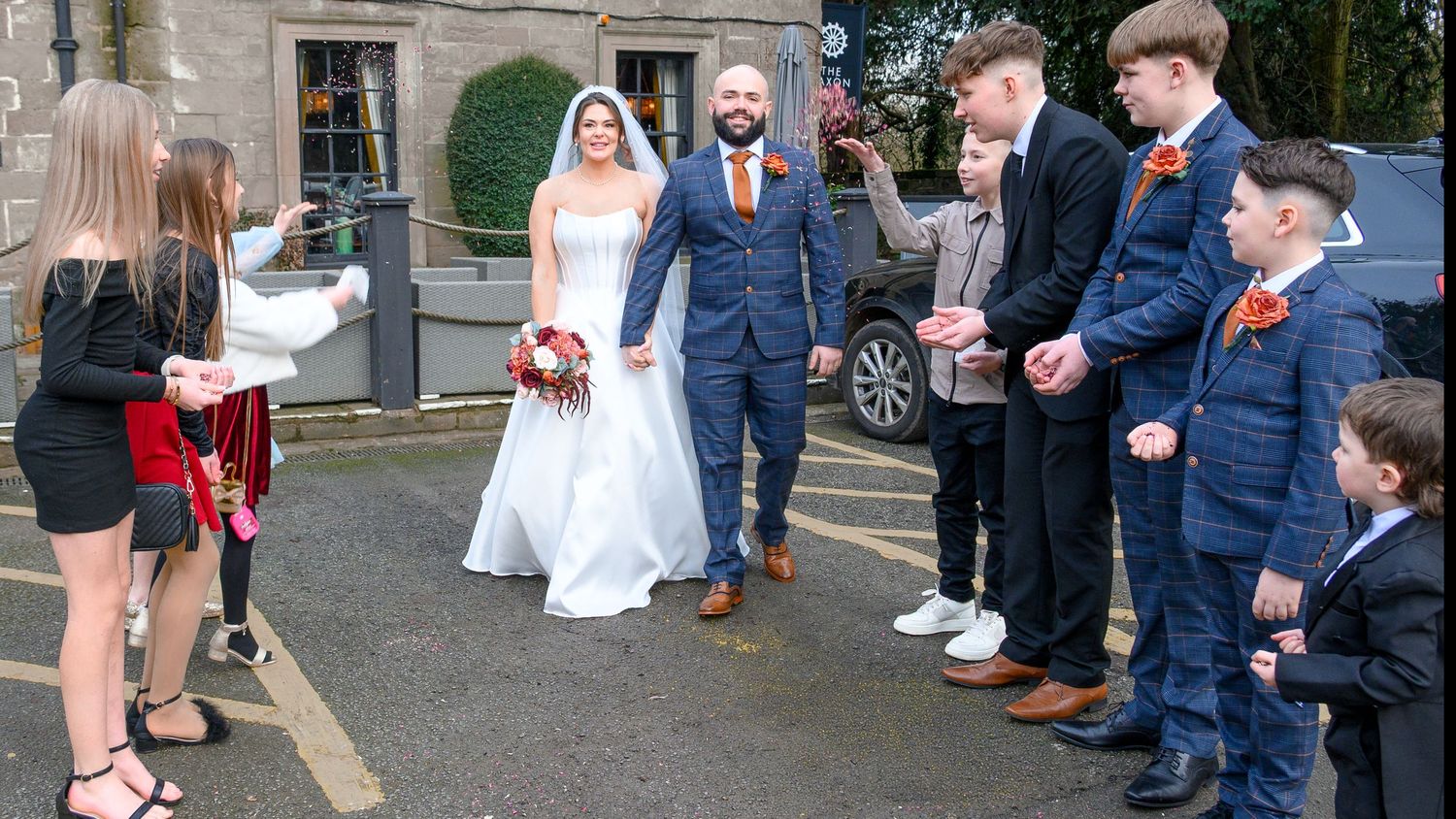 Guests throwing confetti as the bride & groom exit their ceremony at Saxon Mill, Warwickshire – SimplyGreatShots Photography