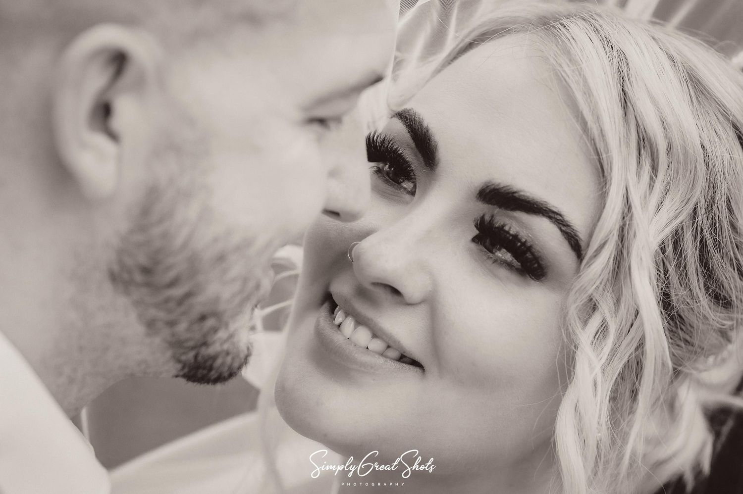 Rothley Court wedding photographer captures an intimate moment where the bride and groom and smiling whilst looking lovingly at each other