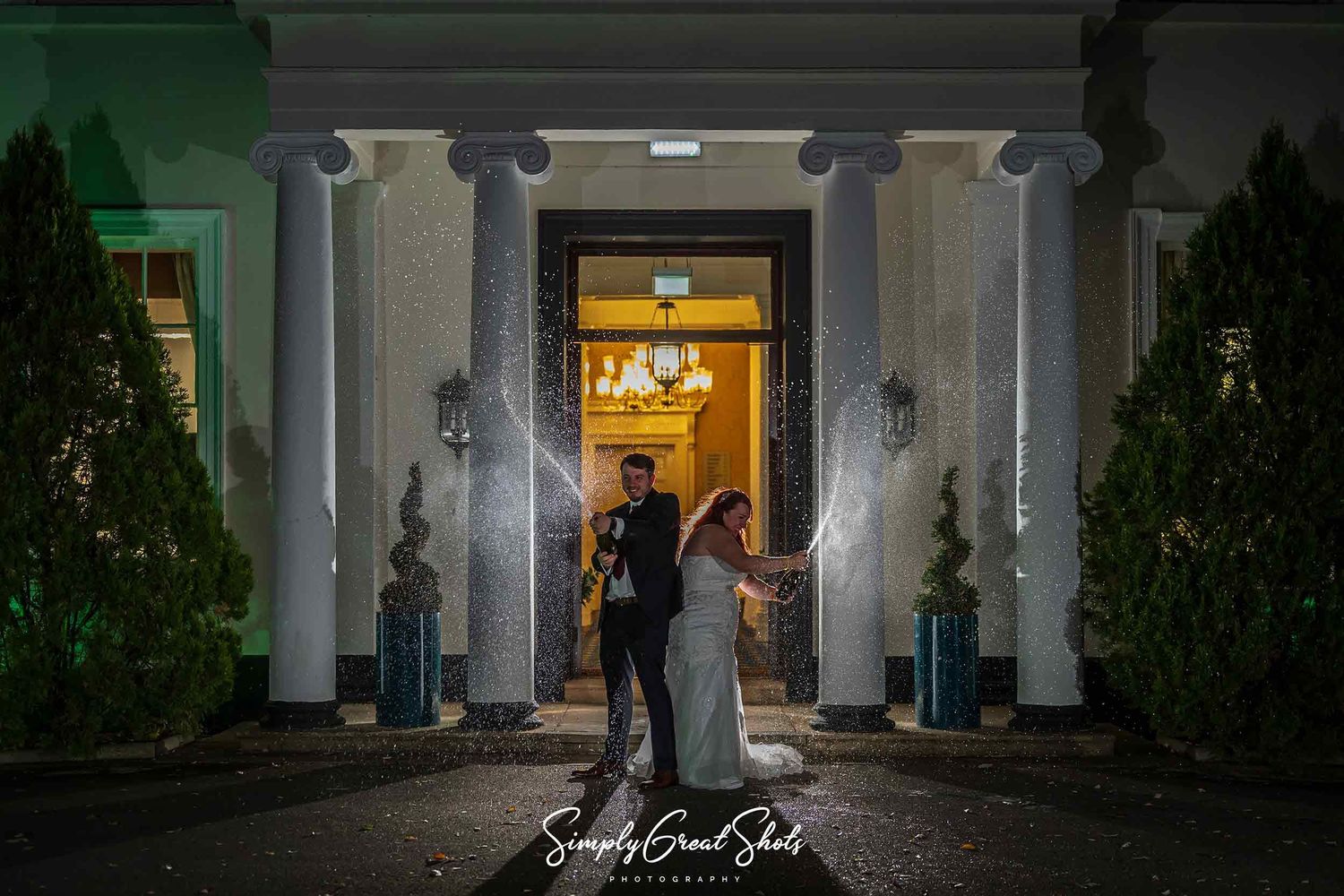 A bride and groom champagne spray at Eastwood Manor