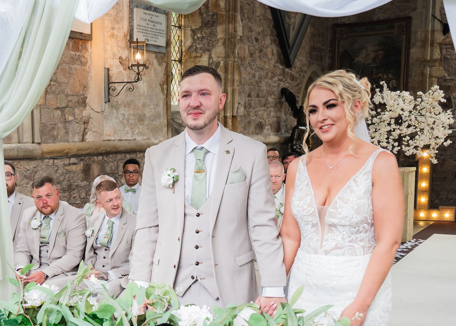 Wedding photos showing moments between the happy couple at a rustic stone venue with elegant decor.