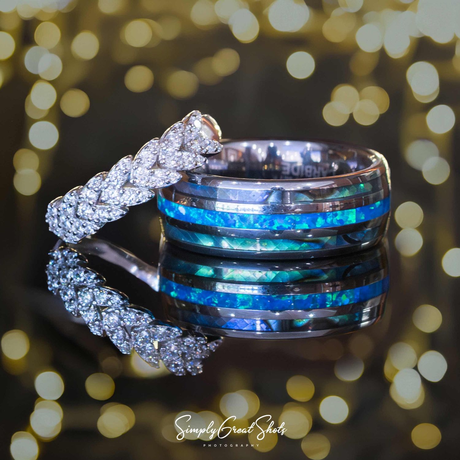 Beaumanor Hall wedding photographer captures the bride and groom's wedding bands, with a reflection and orange bokeh in the background