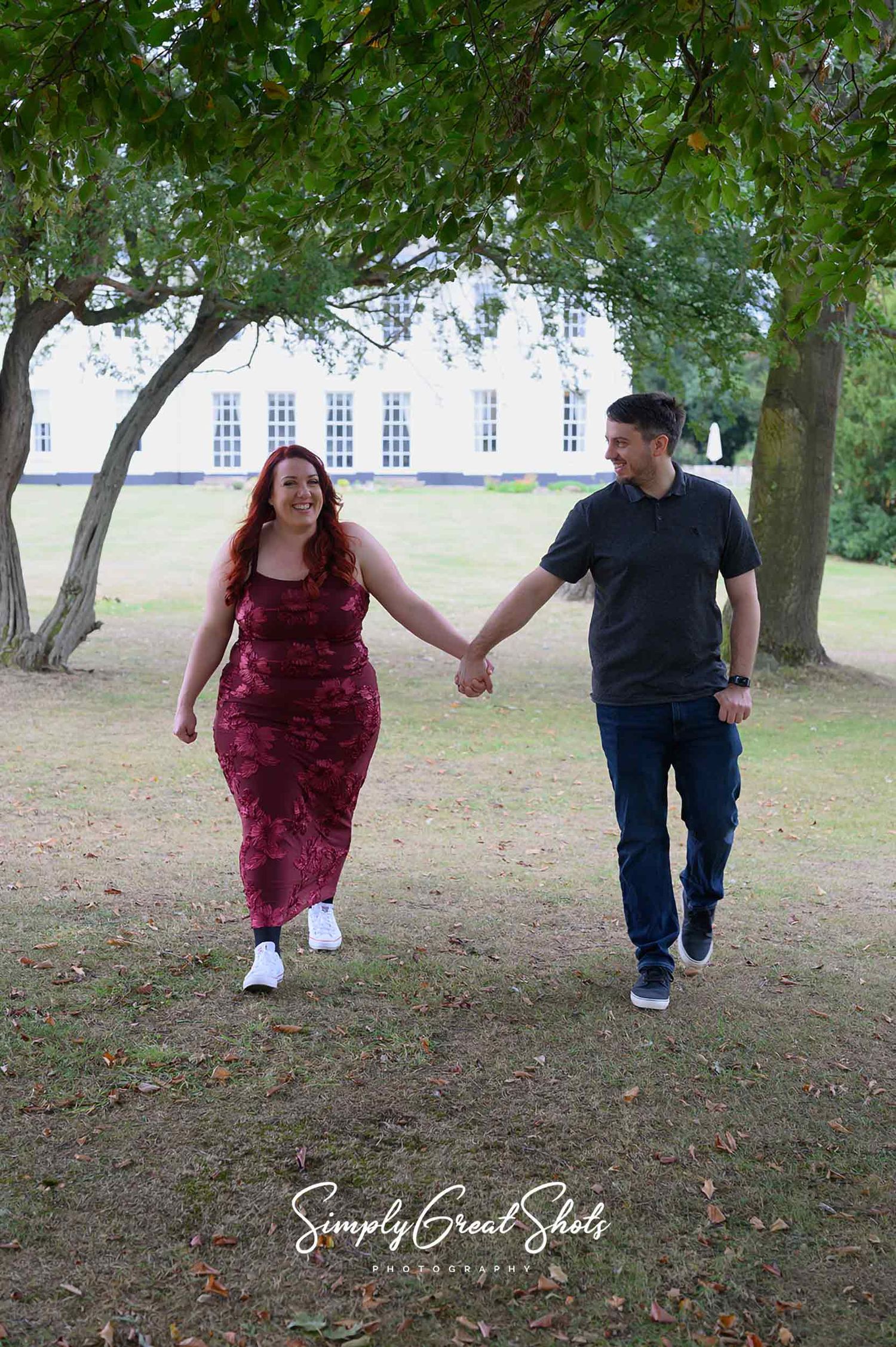 Eastwood Hall wedding photographer captures an engaged couple walking in the gardens at a pre-wedding photoshoot at their wedding venue.