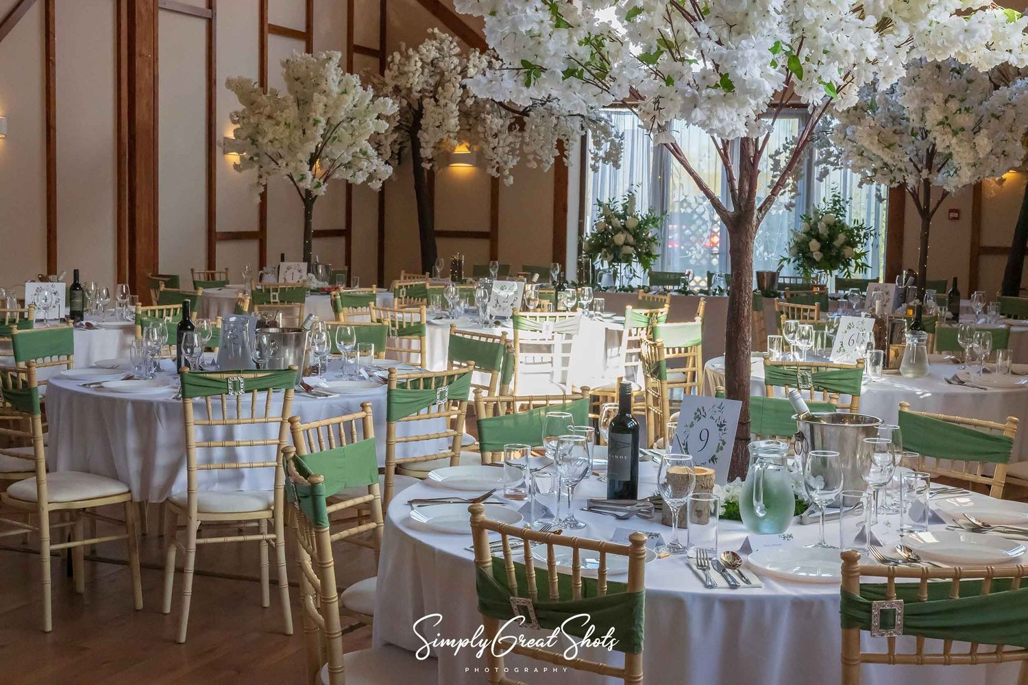 Winters Tale Country Barn wedding breakfast table settings with sage chair Sachs. Photographed by SimplyGreatShots Wedding Photographers
