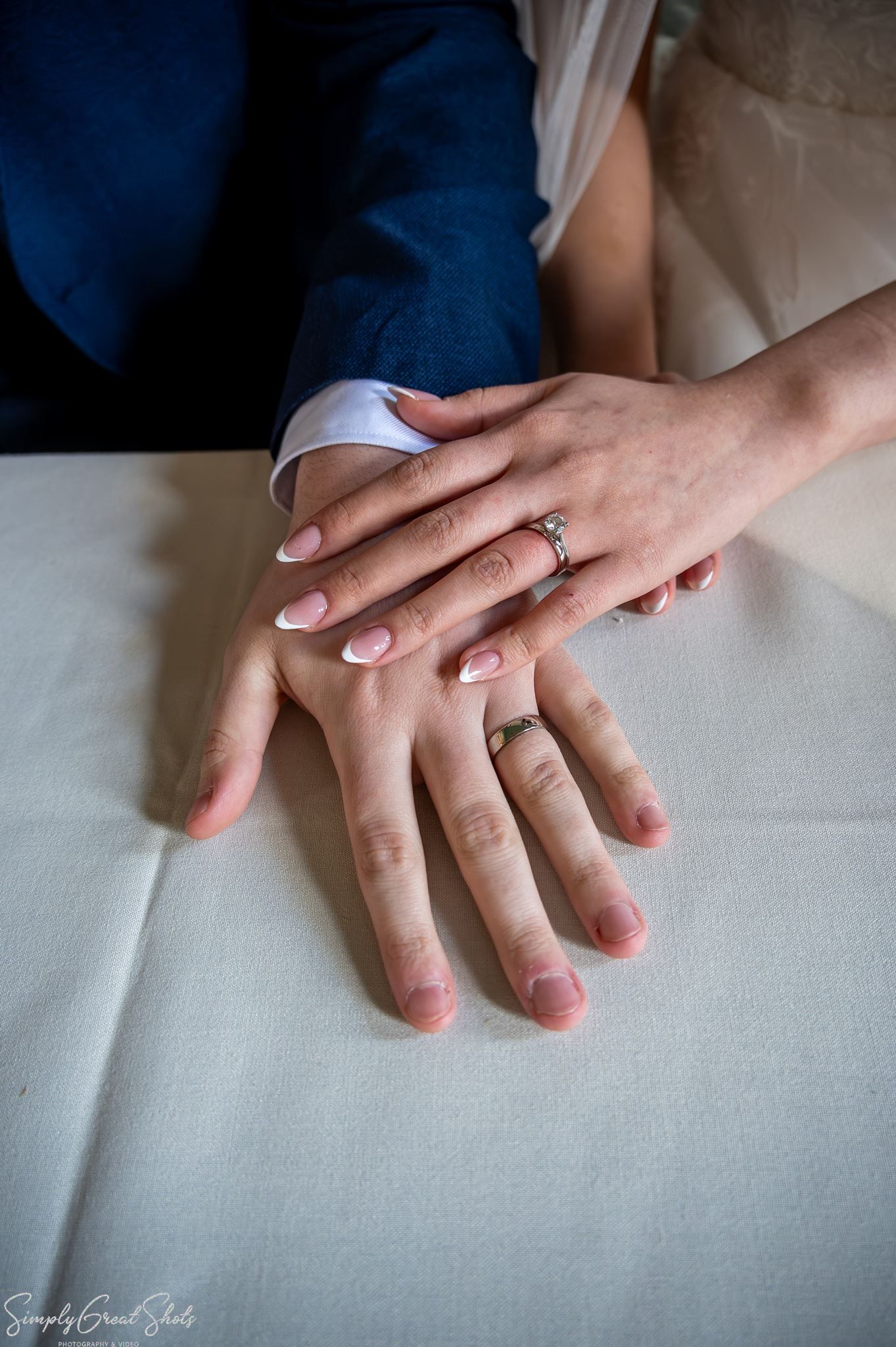 Close-up wedding photography of bride Minky and groom Mark's hands and wedding rings at Coombe Abbey.