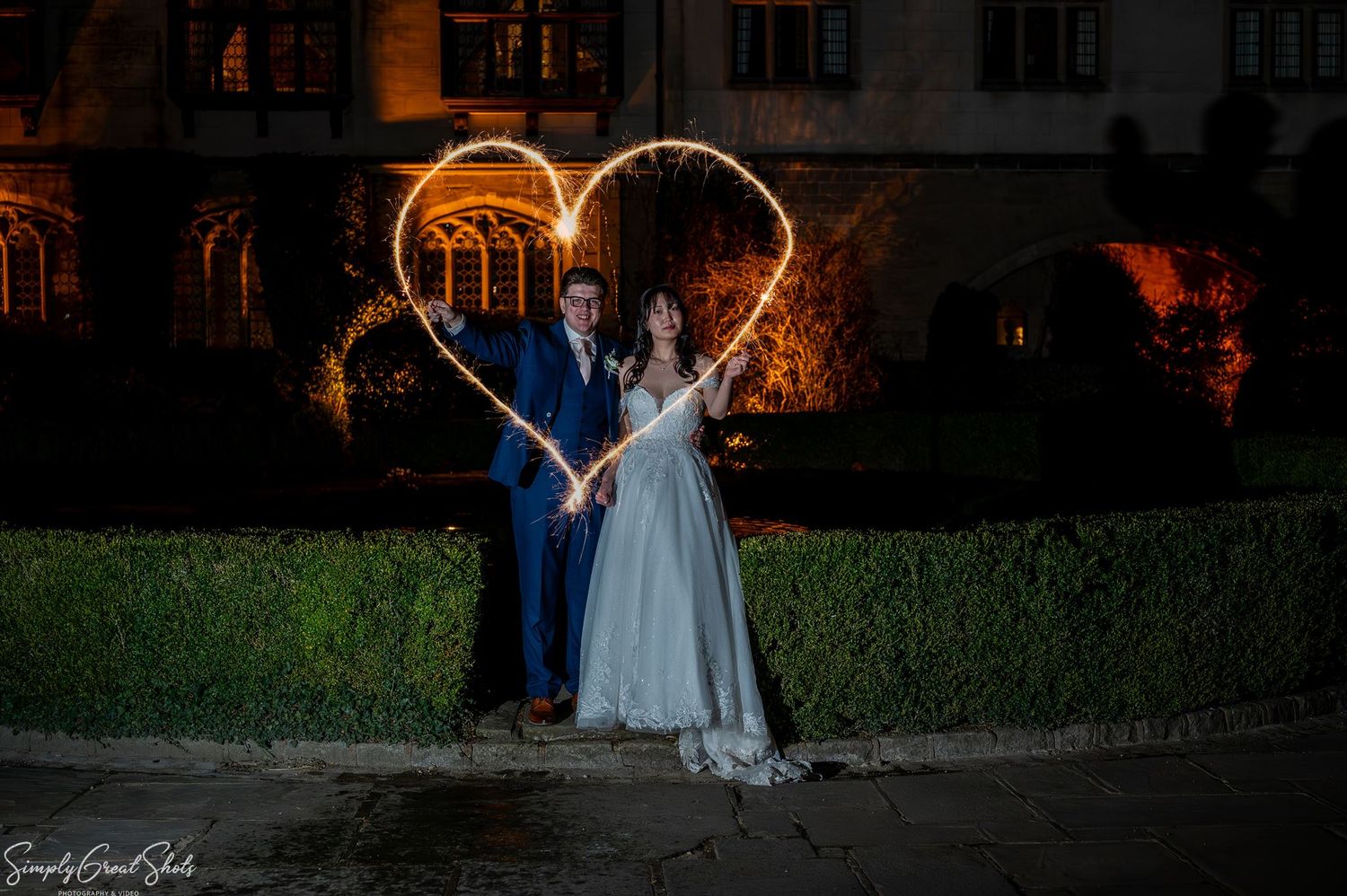 SimplyGreatShots night portrait of bride Minky and groom Mark holding sparklers forming a heart at Coombe Abbey.