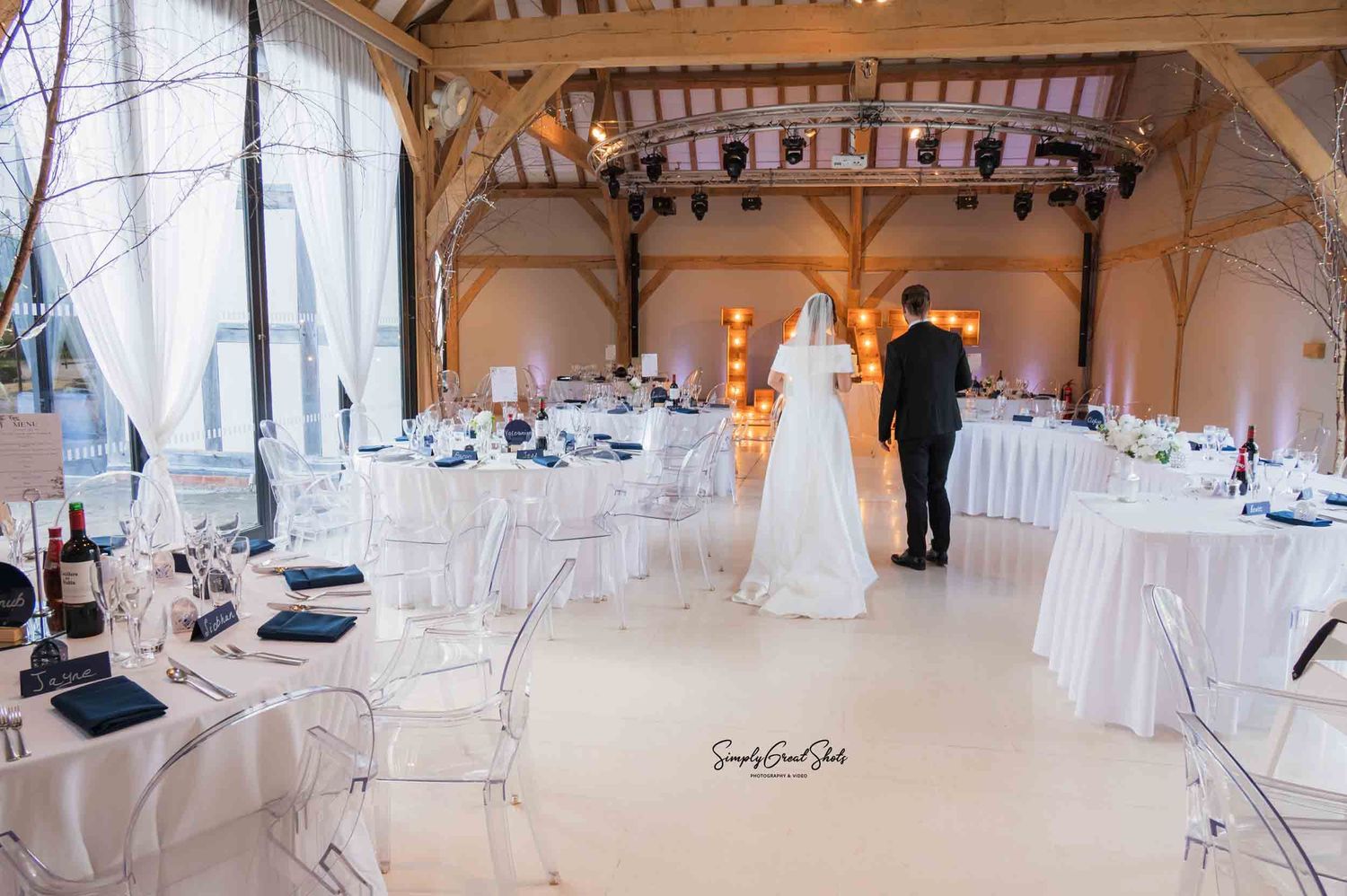 Bride and groom viewing their dressed wedding venue at Redhouse Barn, Worcestershire.