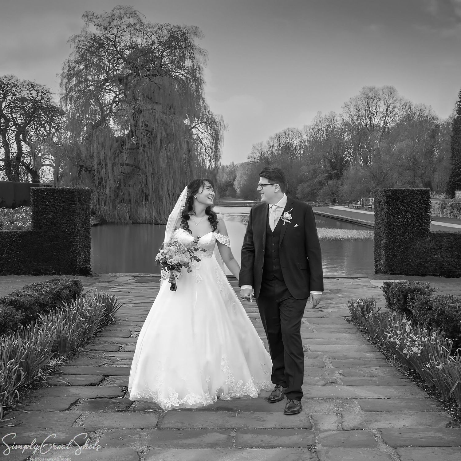 SimplyGreatShots wedding photography of bride Minky and groom Mark walking hand-in-hand in Coombe Abbey gardens.