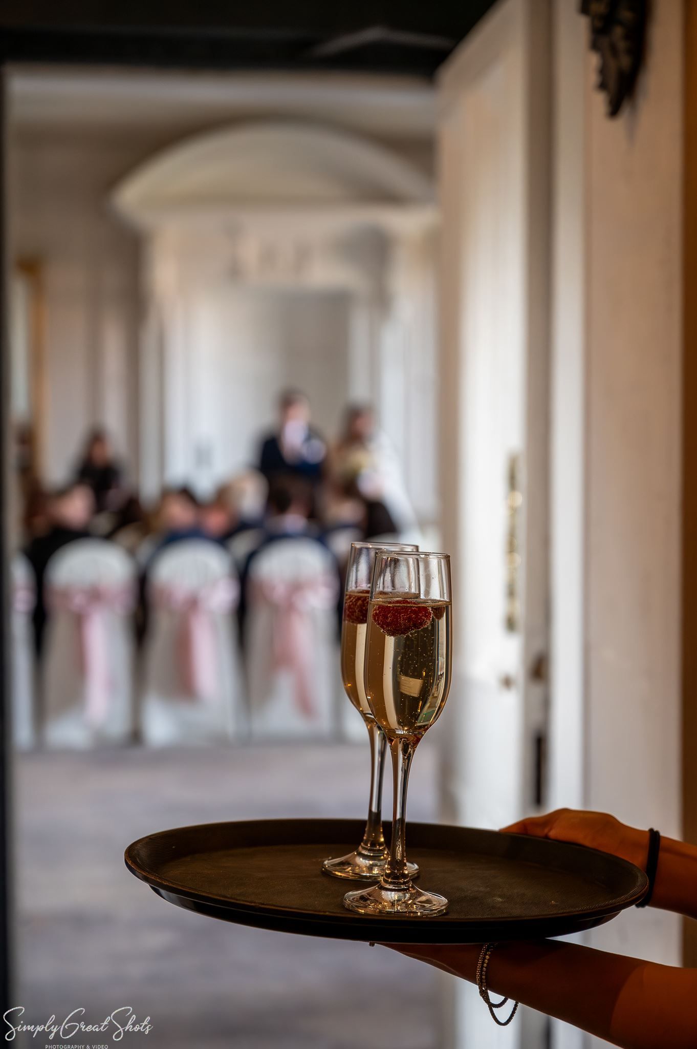 Champagne flutes with fresh raspberries served during the wedding drinks reception at Coombe Abbey.