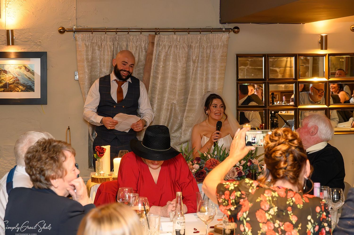 Groom delivering a heartfelt speech while the bride laughs at Saxon Mill, Warwickshire – SimplyGreatShots Photography