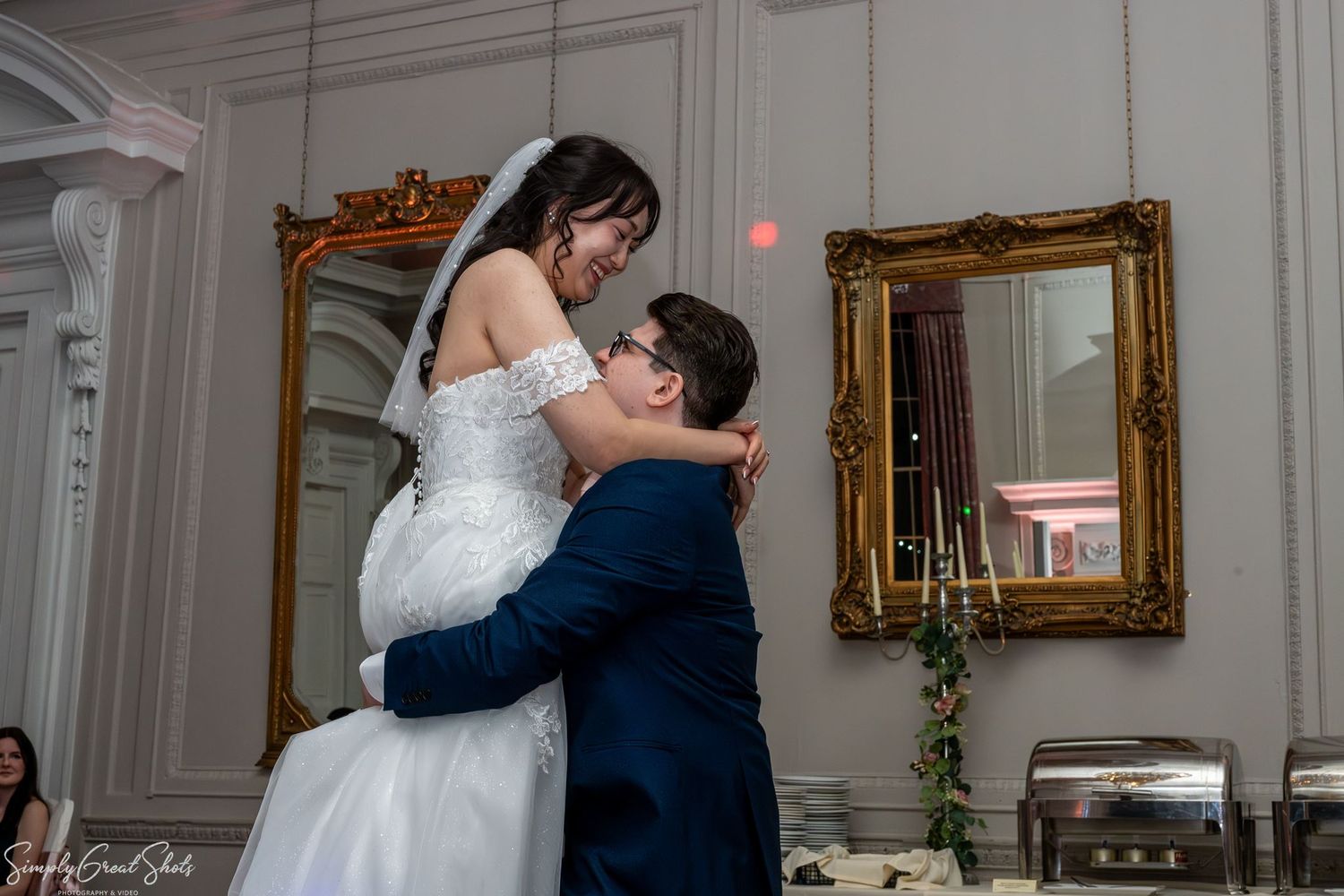 SimplyGreatShots capturing groom Mark lifting bride Minky during their first dance inside Coombe Abbey.