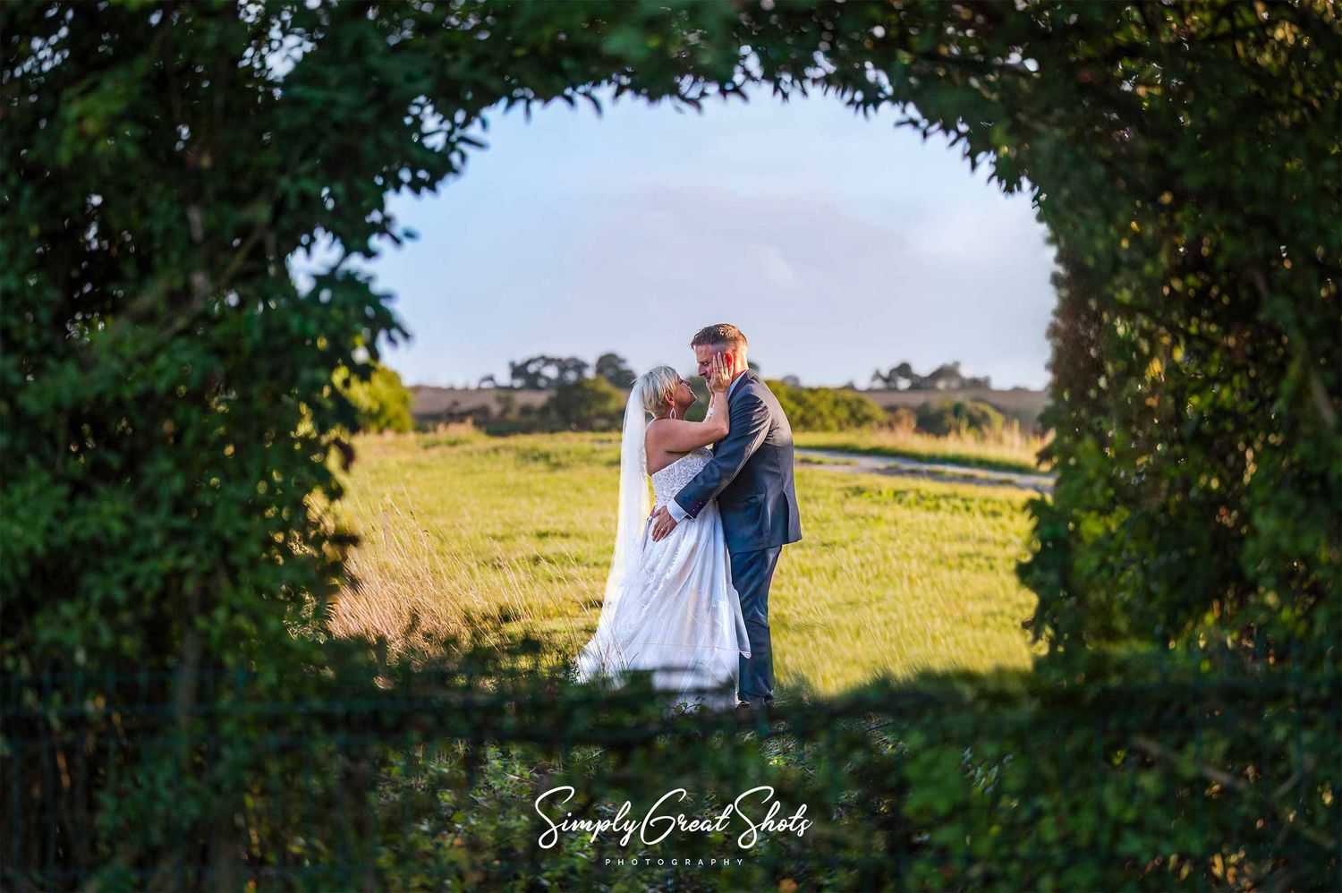Buckinghamshire wedding photographers capture a bride and groom sharing an intimate moment on their wedding day in a secret garden