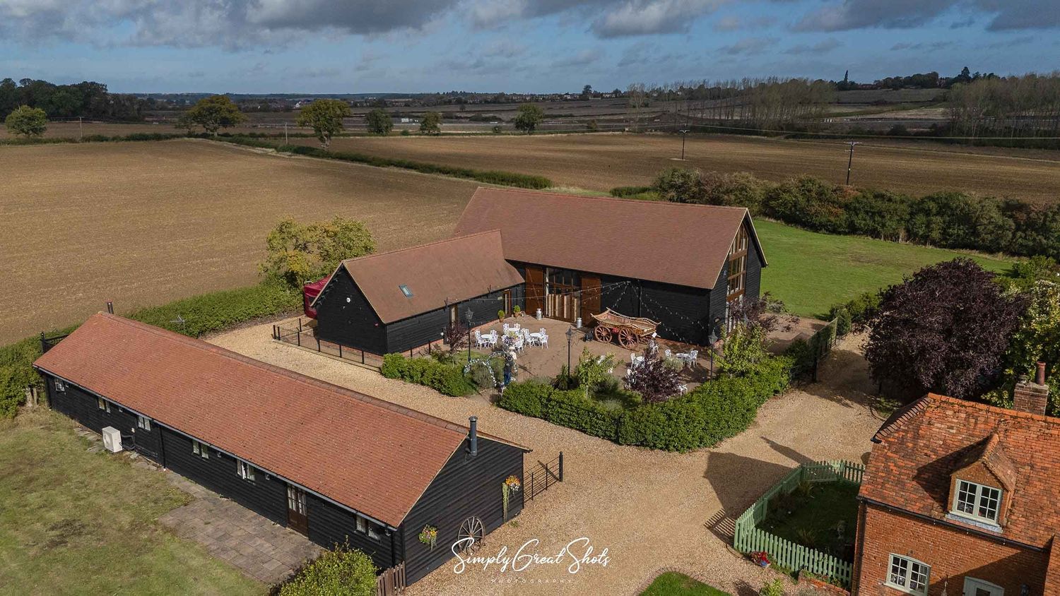 An aerial image of Winters Tale Country Barn in Buckinghamshire with open fields in the background captured by a wedding photographer.