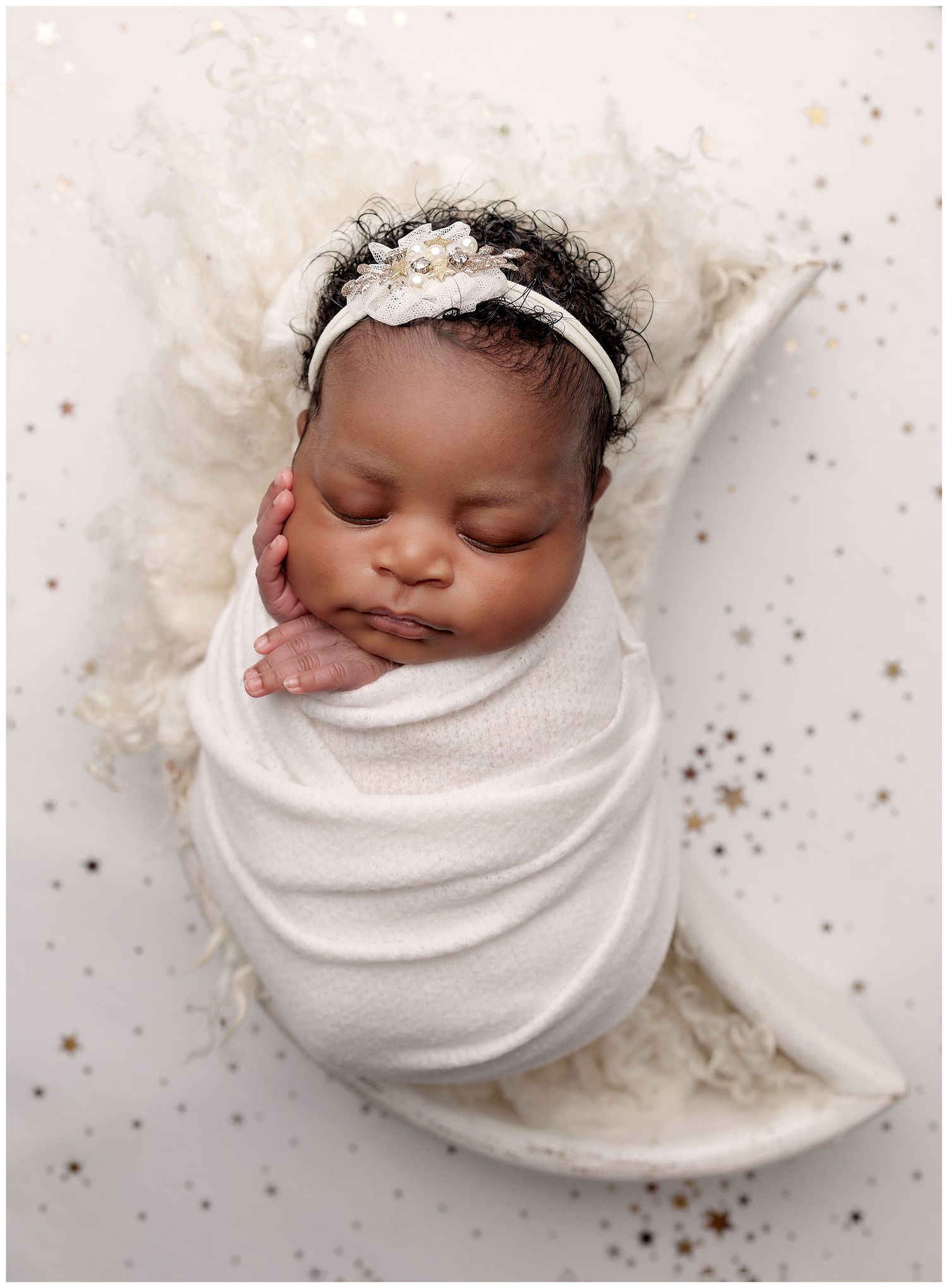 Austin newborn photography studio portrait of baby swaddled in white wrap on soft neutral background
