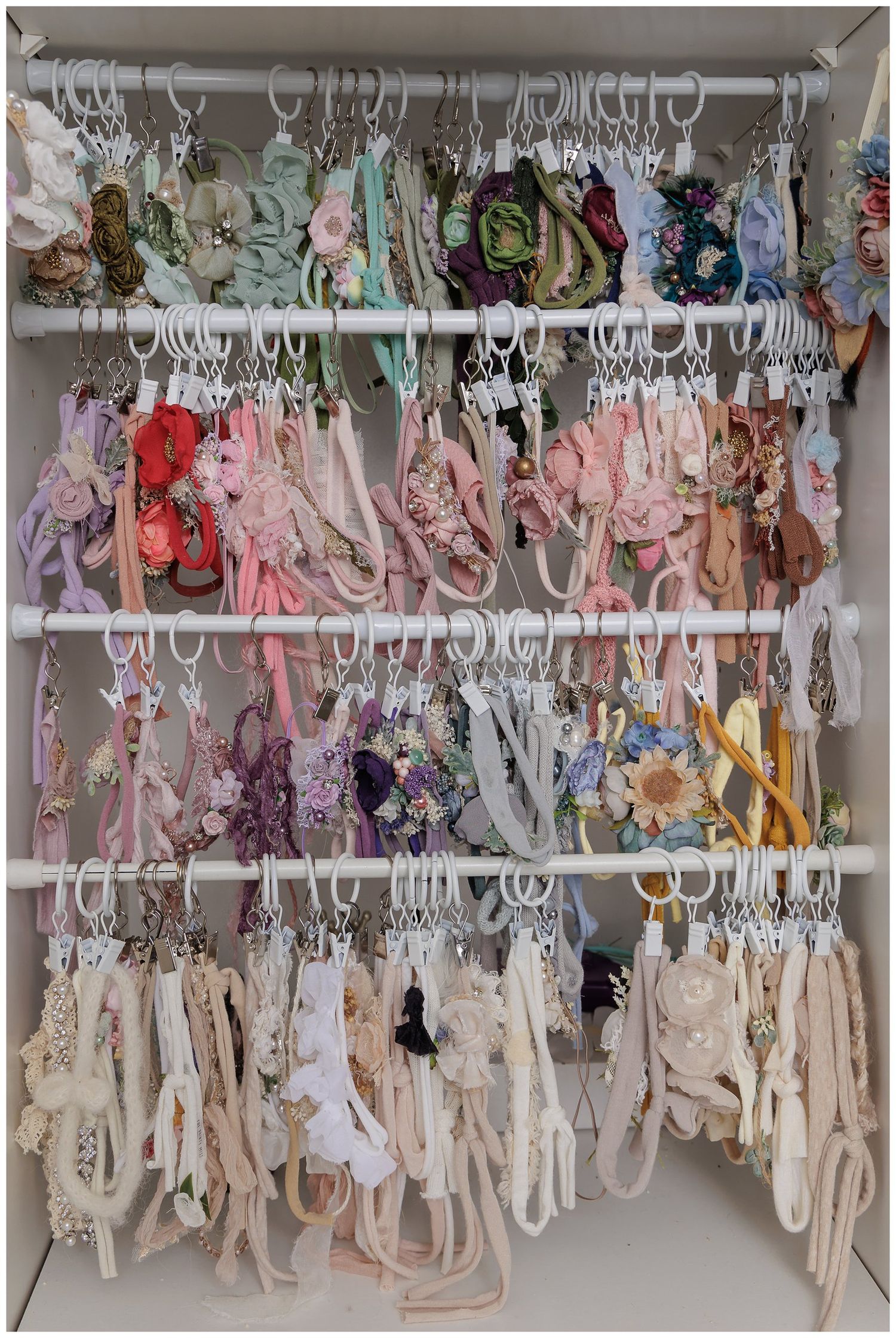 Valerie Kay Photography studio client wardrobe display with newborn wraps, outfits, and accessories