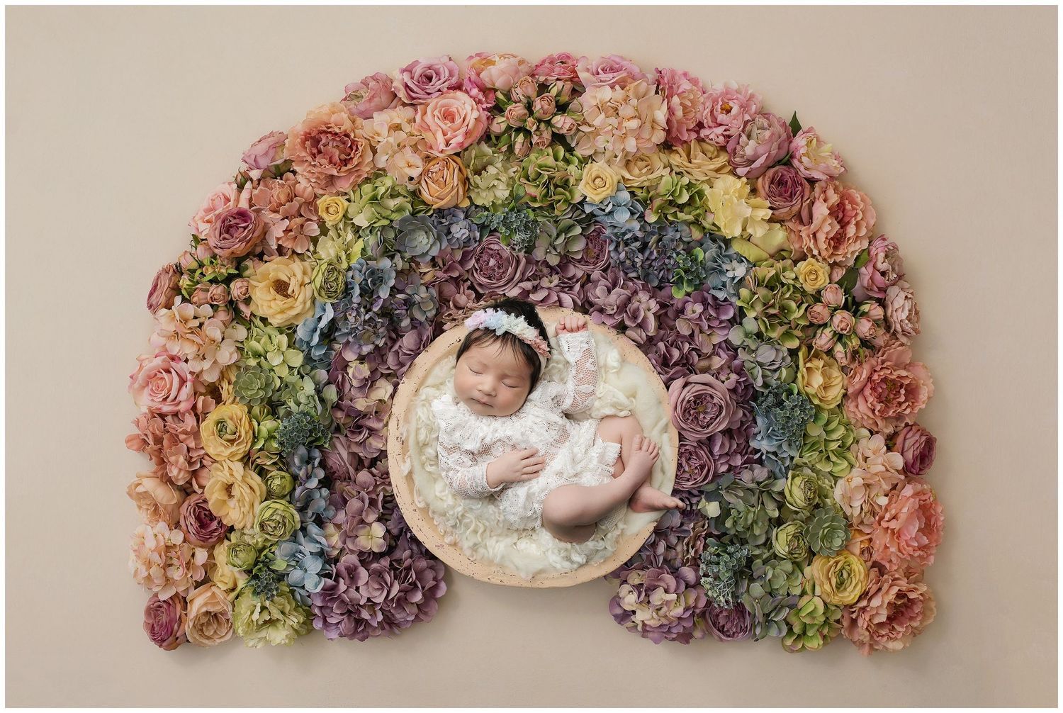 Austin Newborn baby posed in the center of a rainbow  of flowers at valerie kay photography studio