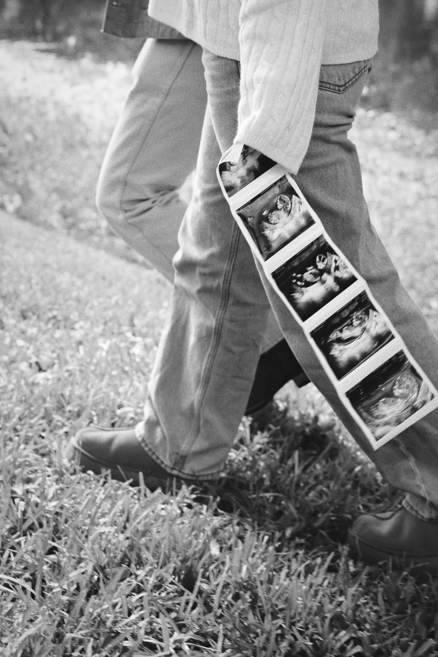 couple walking with black and white ultrasound photo
