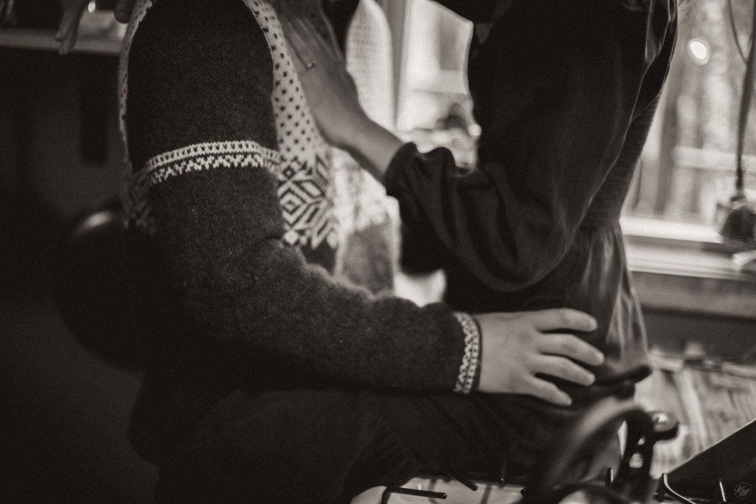 Vintage black and white closeup of someone wearing a winter sweater with patterned details and woman wearing denim dress Southeast Alaska.