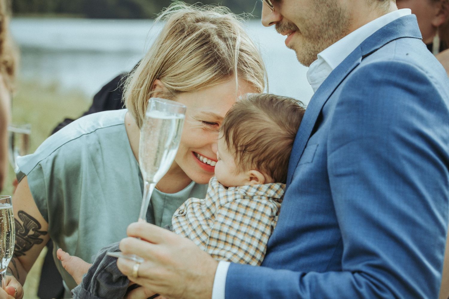 An intimate family moment shared outdoors on a sunny day.