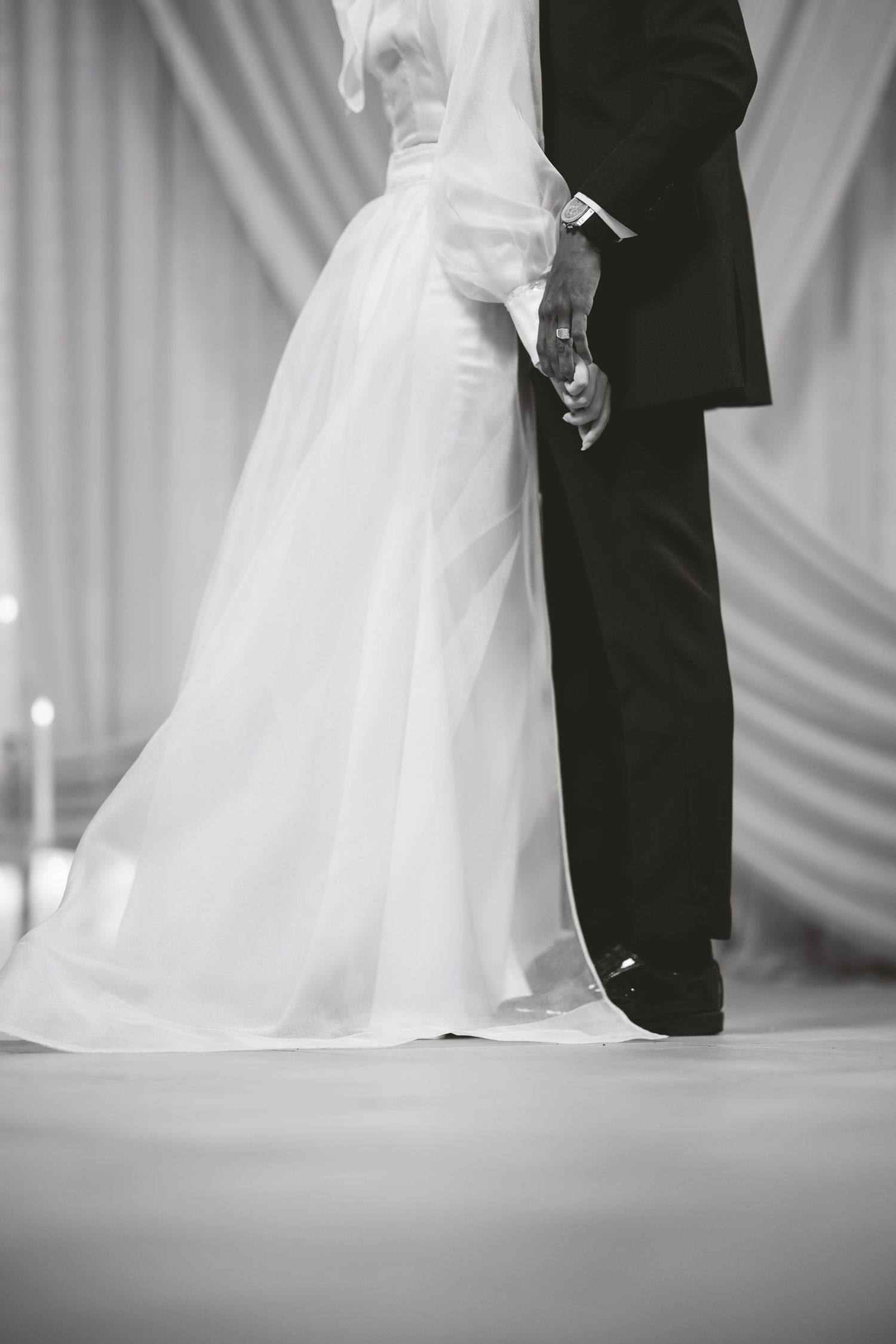 Black and white sequence showing a couple's first dance with flowing white wedding dress.