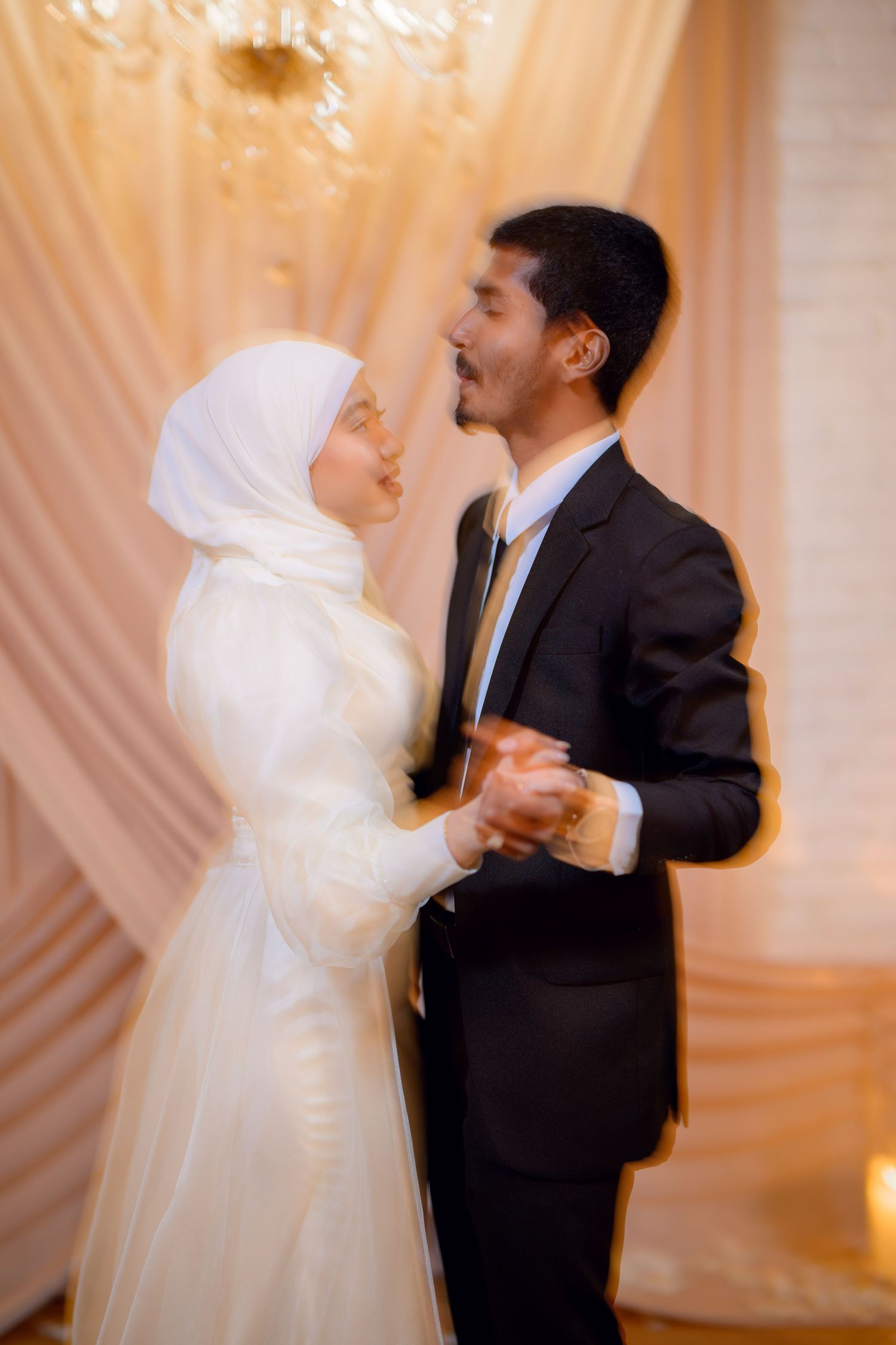 Romantic dance sequence of newlyweds in traditional wedding attire.