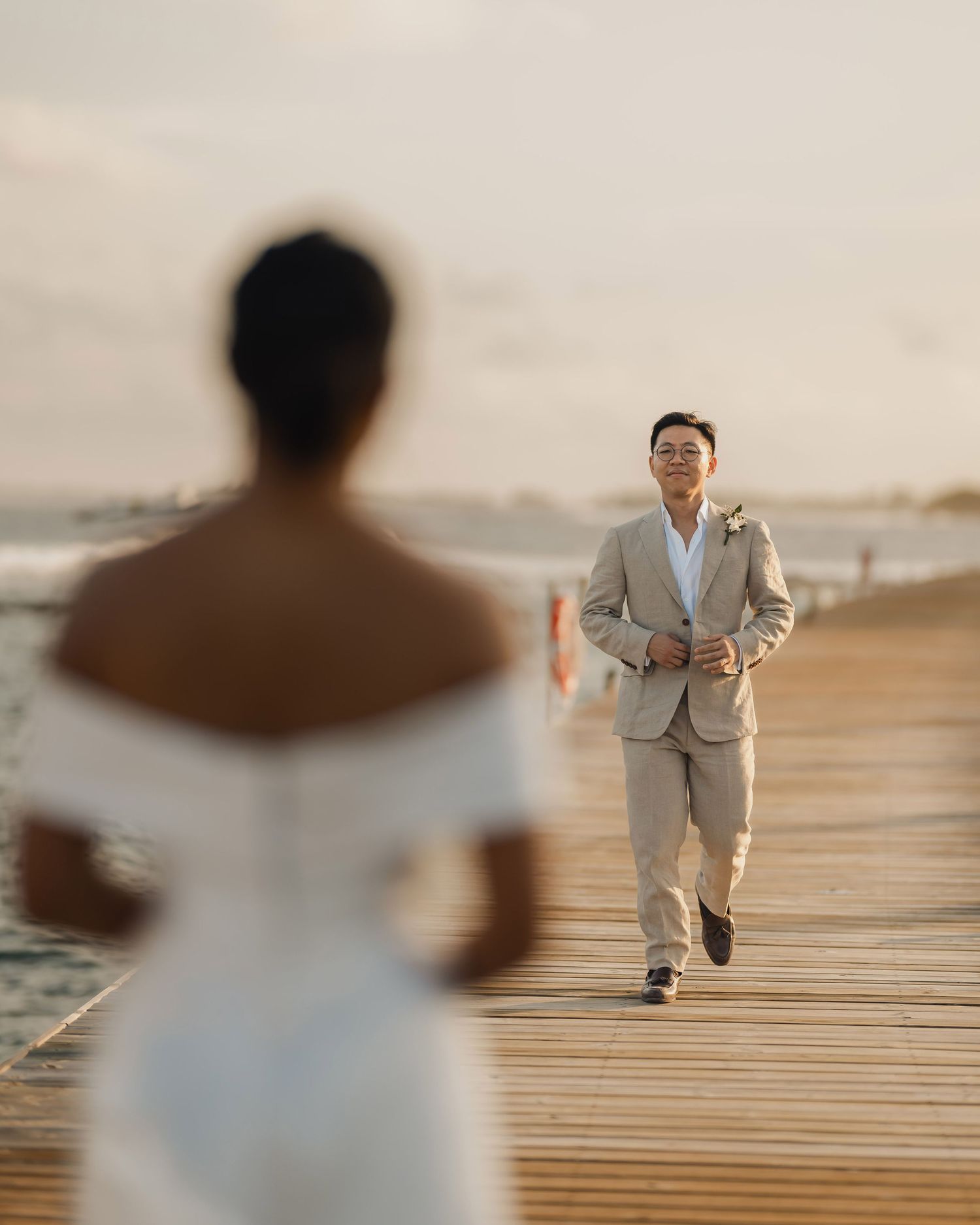 Wedding sequence showing playful moments on a wooden dock by the water.