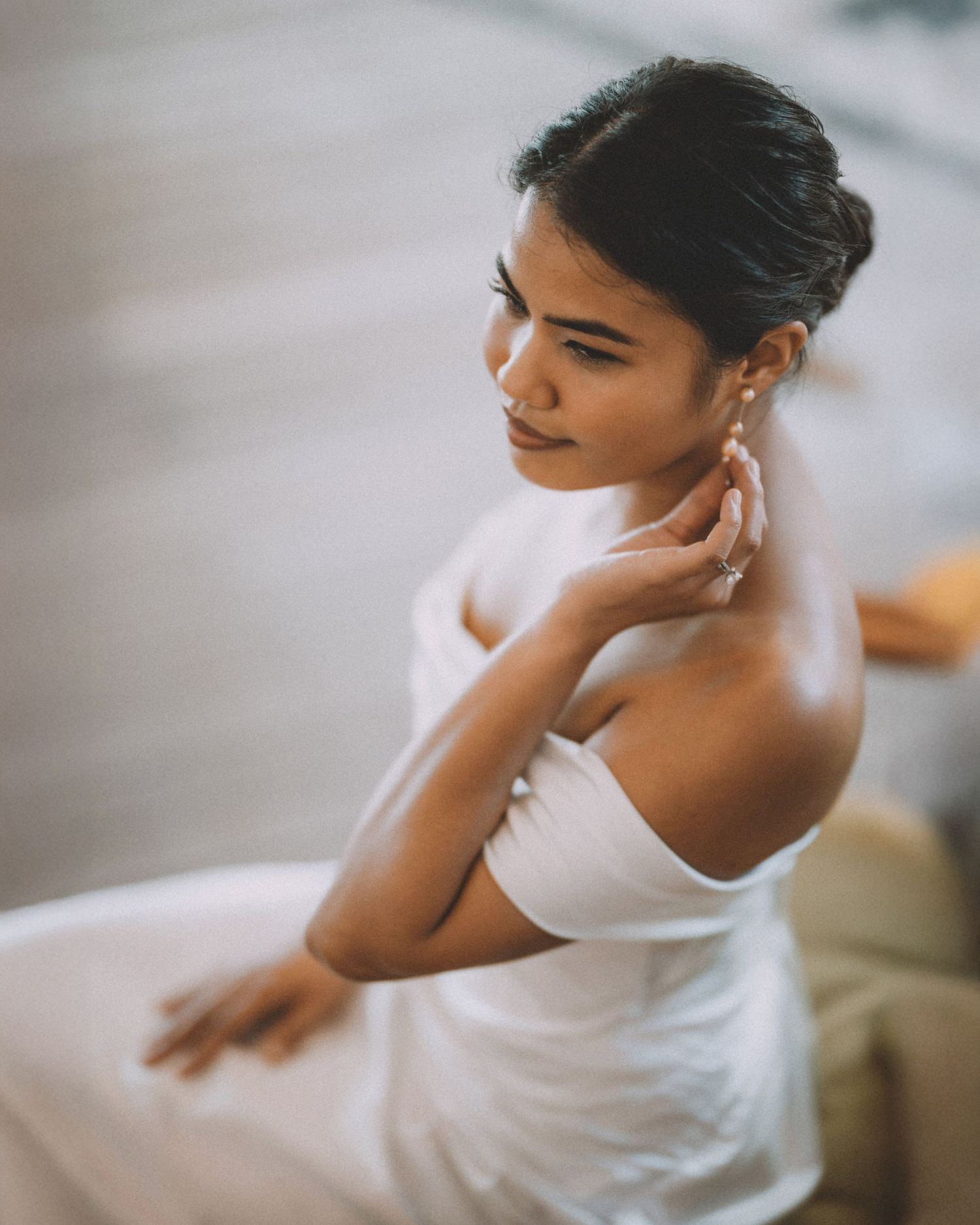 Elegant off-shoulder white wedding dress detail shot.