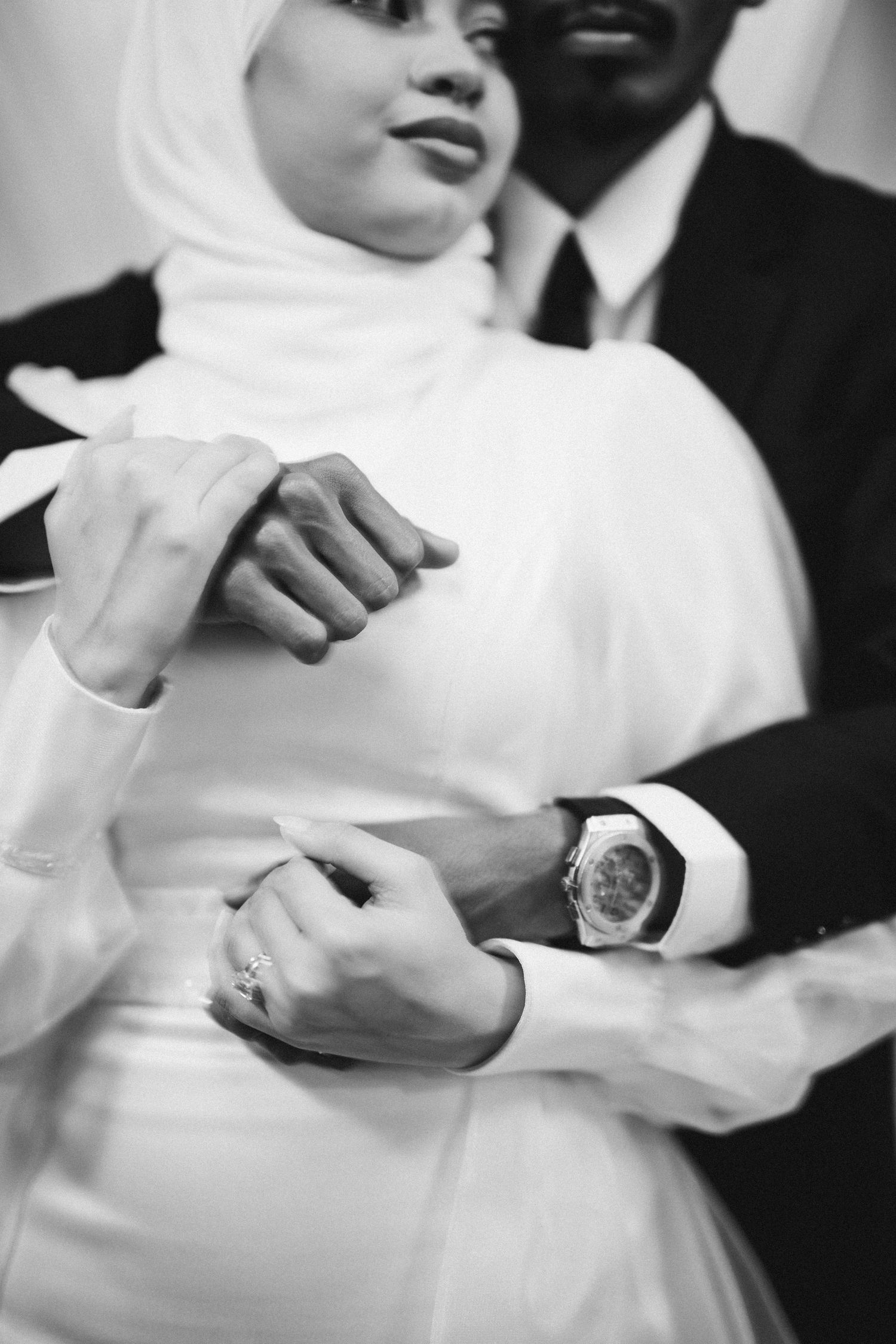 Black and white sequence showing hands and wedding rings during ceremony.