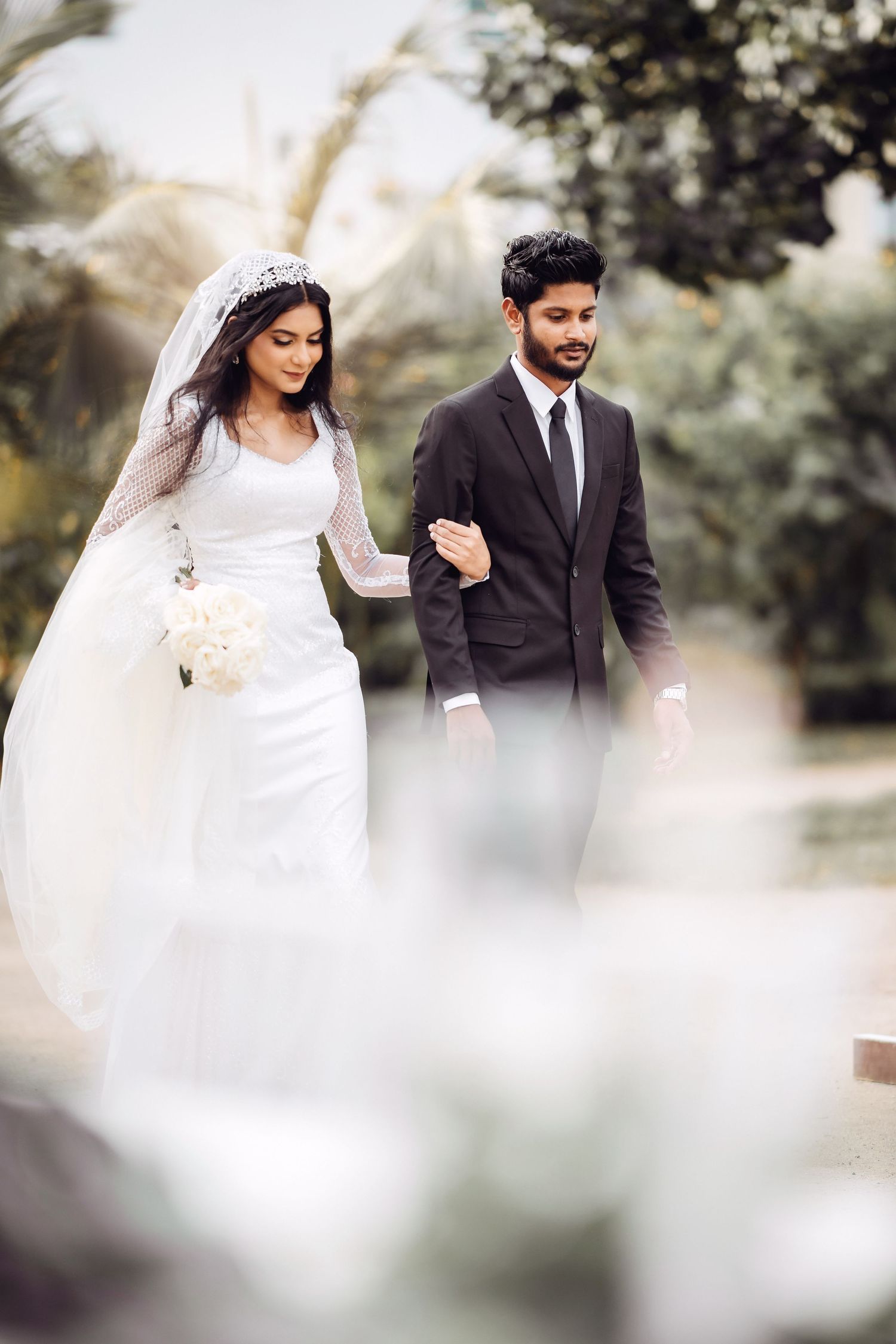 A romantic wedding photoshoot in a dreamy garden setting with soft lighting.
