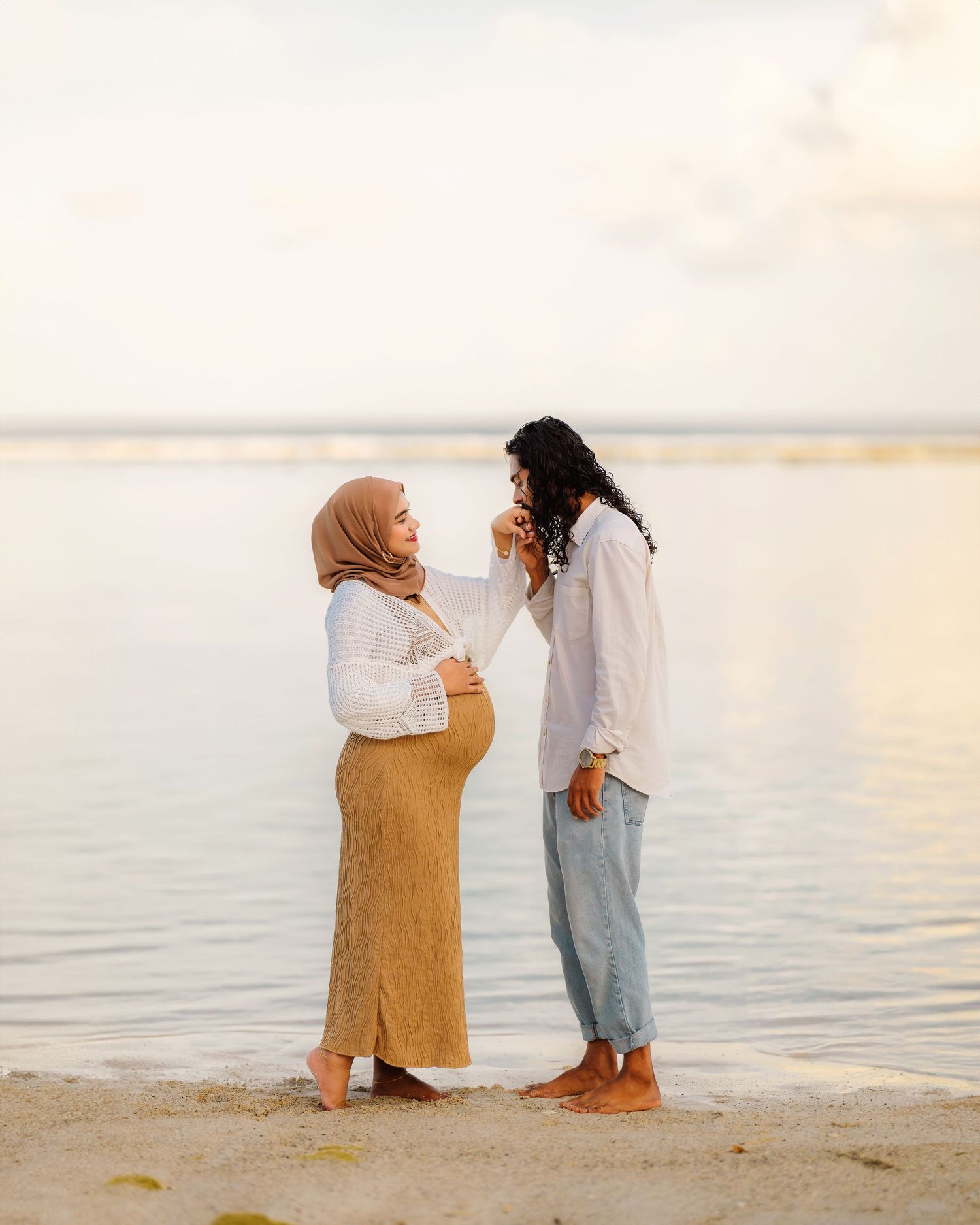 Friends sharing joyful moment together on beach at sunset.
