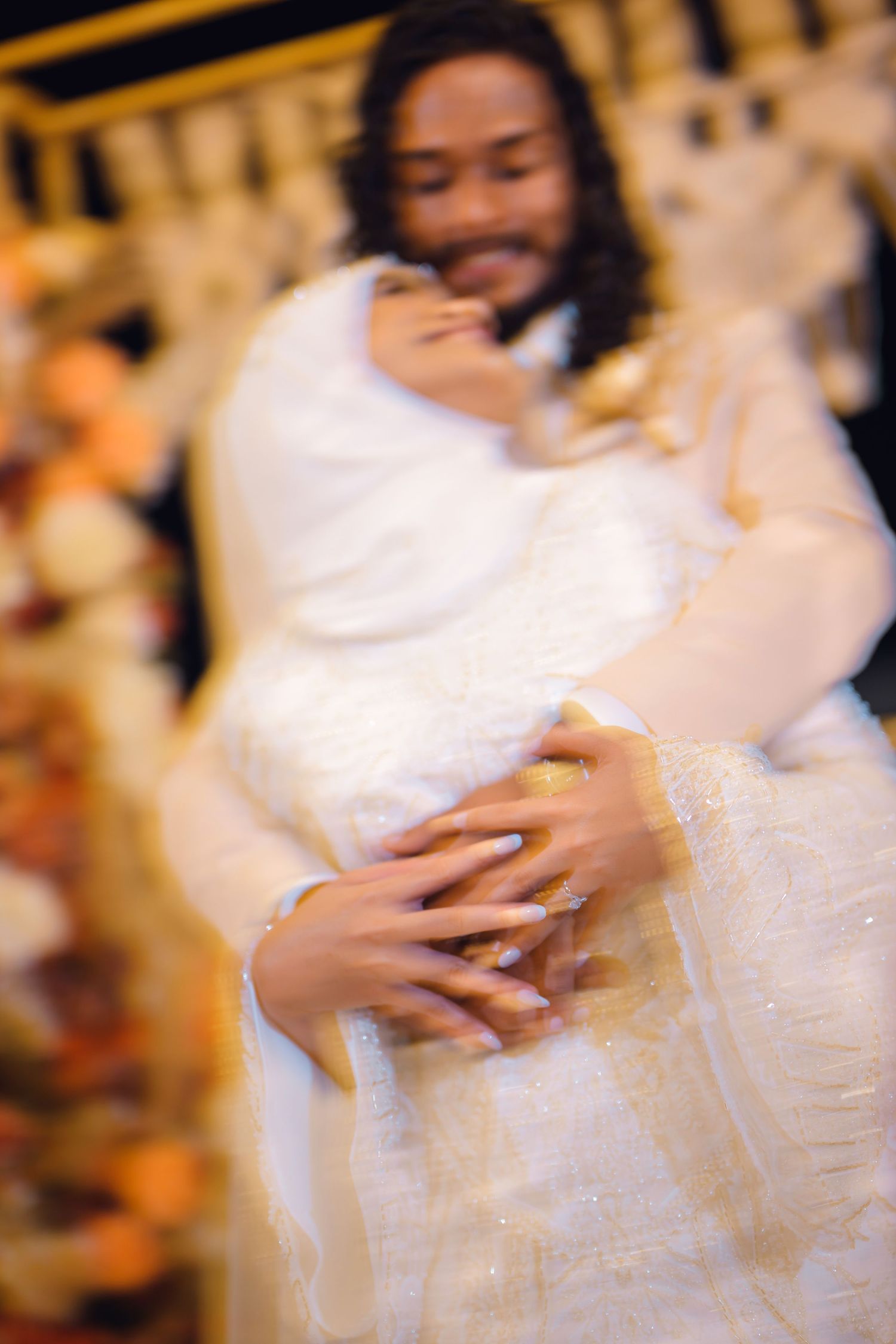 Artistic blurred portrait of bride in white dress with soft focus effect.