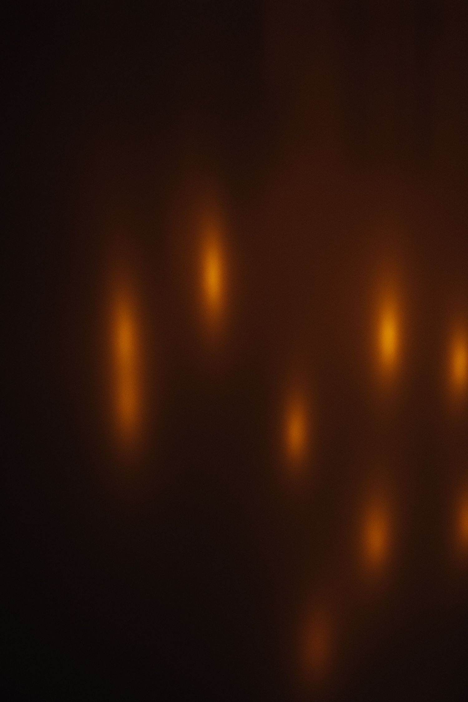Abstract blurred bokeh background with warm golden orange glowing lights on dark background. New Orleans, Louisiana, Mississippi