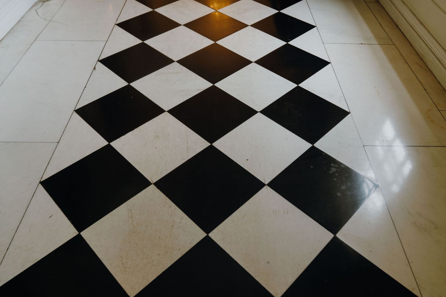 Classic black and white diamond-patterned marble floor tiles in an elegant venue interior. New Orleans, Louisiana, Mississippi